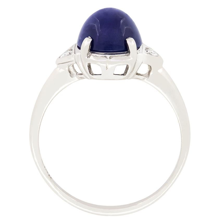 A stunning cabochon cut, star sapphire takes centre stage in this late deco solitaire ring. claw set into a ring crafted in 18 carat white gold, the deep blue sapphire is an impressive 3.75 carat and true to its name, shows off a white star shape in