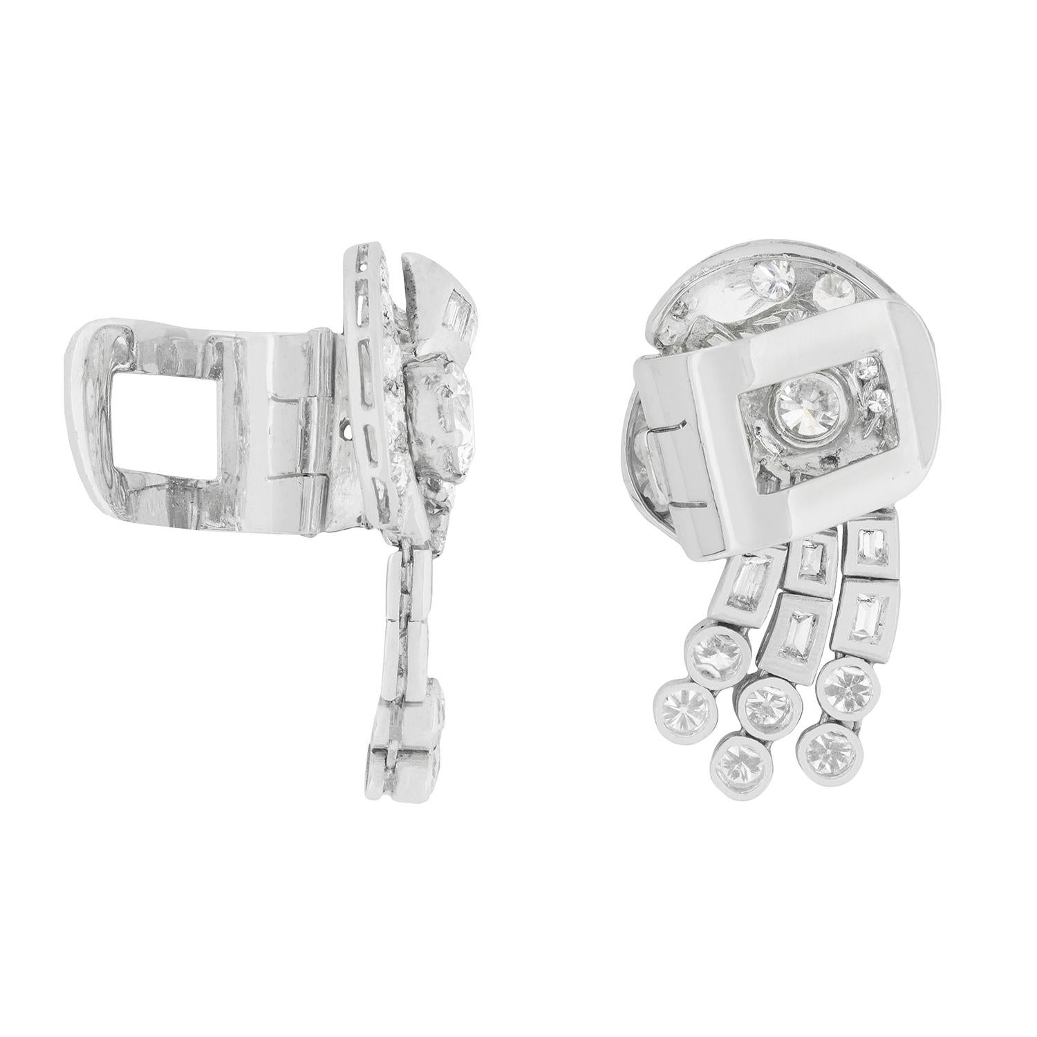 These absolutely breathtaking earrings date back to the 1930s and feature an array of transitional cut and baguette cut diamonds, all perfectly set within platinum. On each earring, there is a centre round transitional cut diamond with a weight of