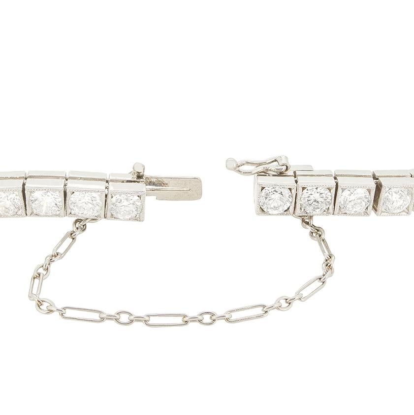 This beautiful Late Deco diamond line bracelet features a total of 6.90 carat in sparkling round brilliant diamonds. Each of the forty-six diamonds is box set in platinum to form the 17cm long line bracelet. Each diamond is of good quality with