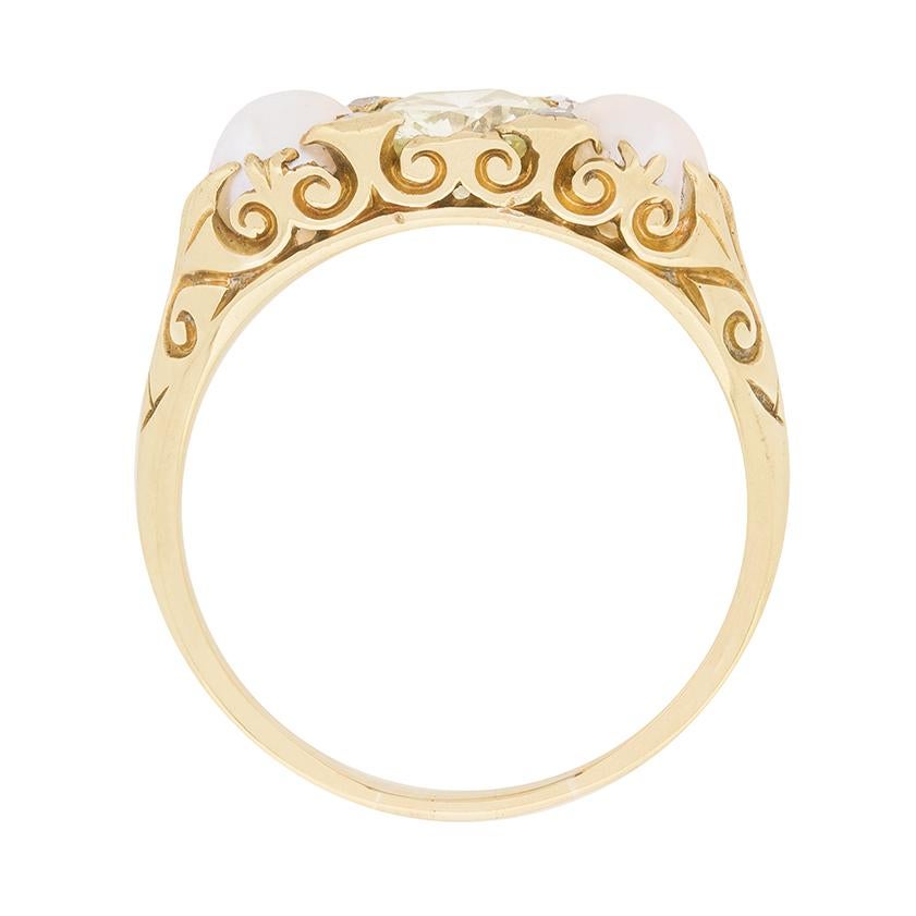 A truly unique ring, inspired by the Victorian era, but dating to the 1940s. It features a round brilliant diamond in the centre, which is a fancy yellow in colour. It gleams in the middle of the adjacent pearls, which are natural and match in size.