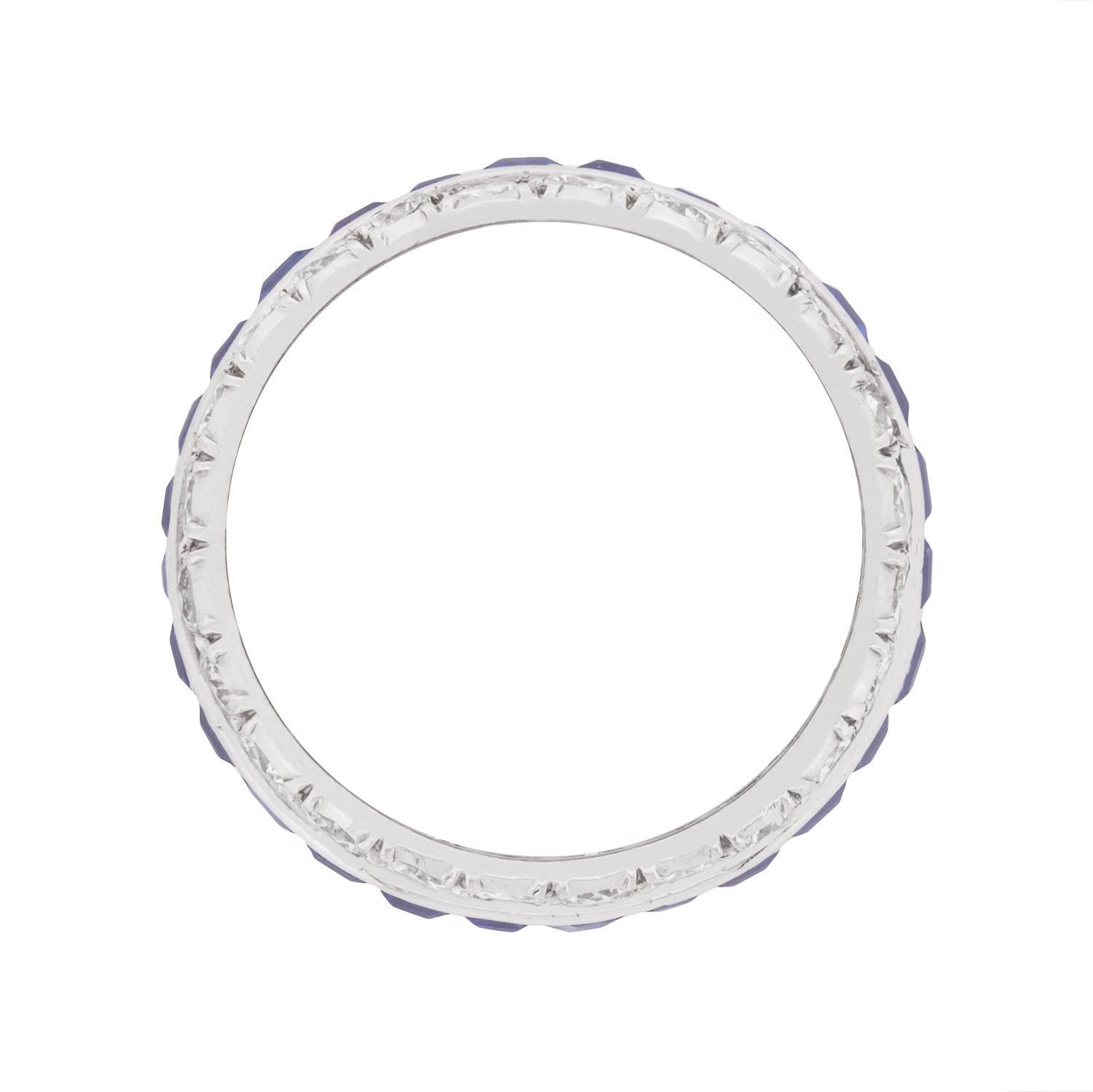 This beautifully made eternity ring boasts a total carat weight of 2.70 carat's worth of deep blue sapphires. They are baguettes cuts, all hand crafted and expertly tension set to calibrate with one another. These stunning gemstones have been