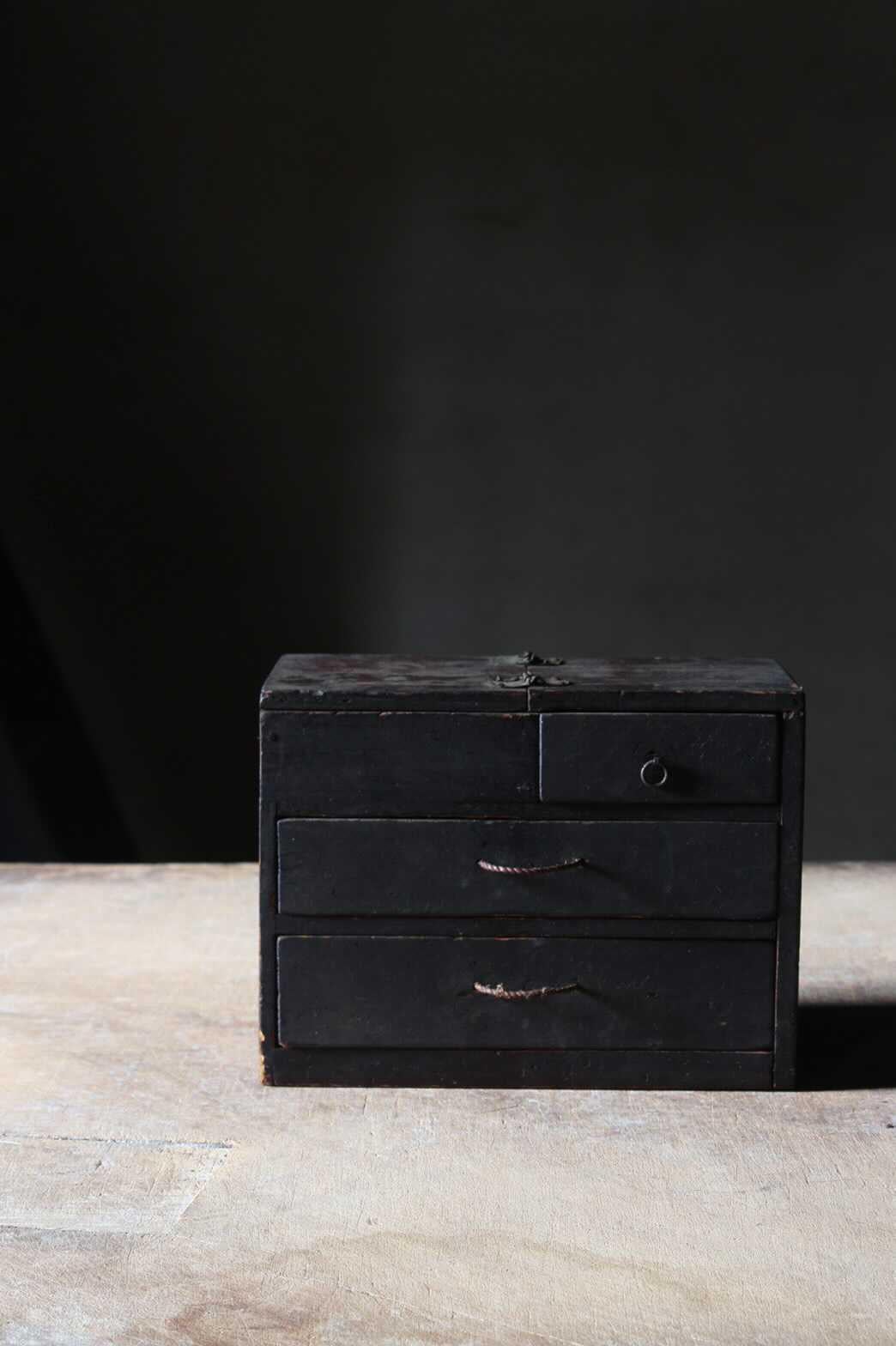 This is a beautifully worn late Edo period small chest of drawers for sewing. Made of Cedar with iron handle and hinge. The whole look is rustic, blackened and simple, with refined details like the top is foldable with a candle holder revealed at