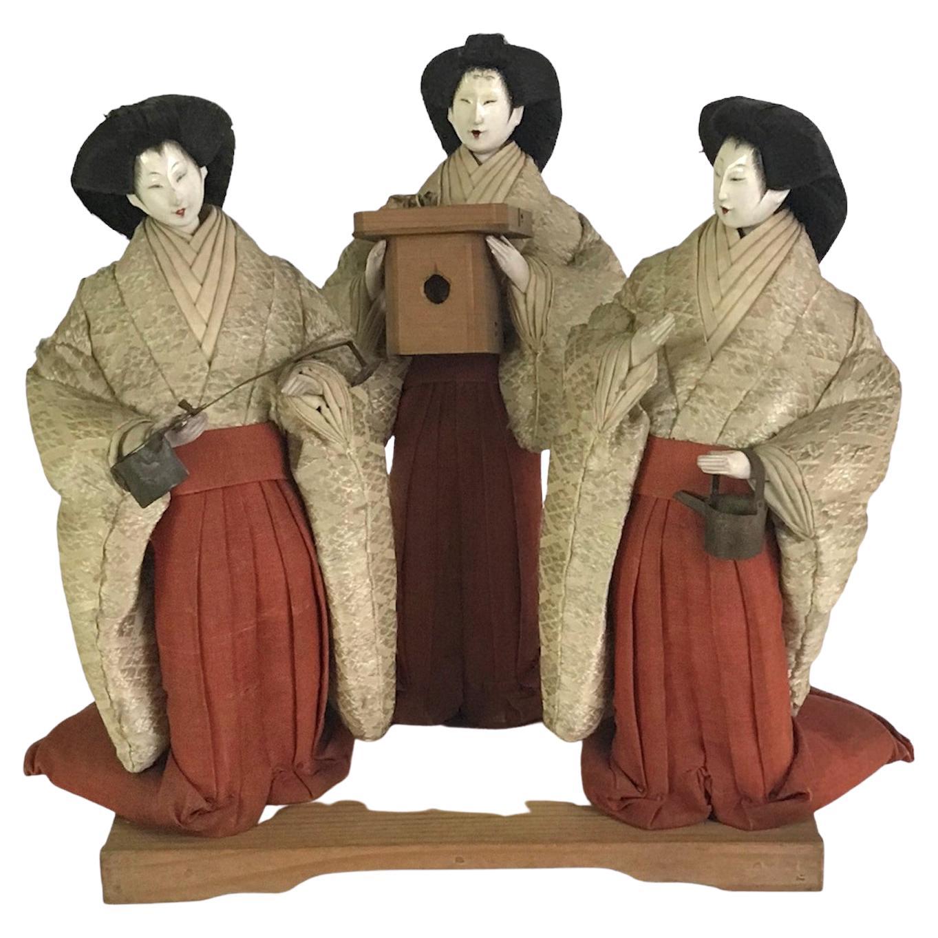Late Edo Period Dolls representing Sannin-kanjyo which means the three court ladies. They support and care for the emperor (Odairi-sama) and the empress consort (Ohina-sama).   All are wearing a Japanese traditional dress (colored red and white). 