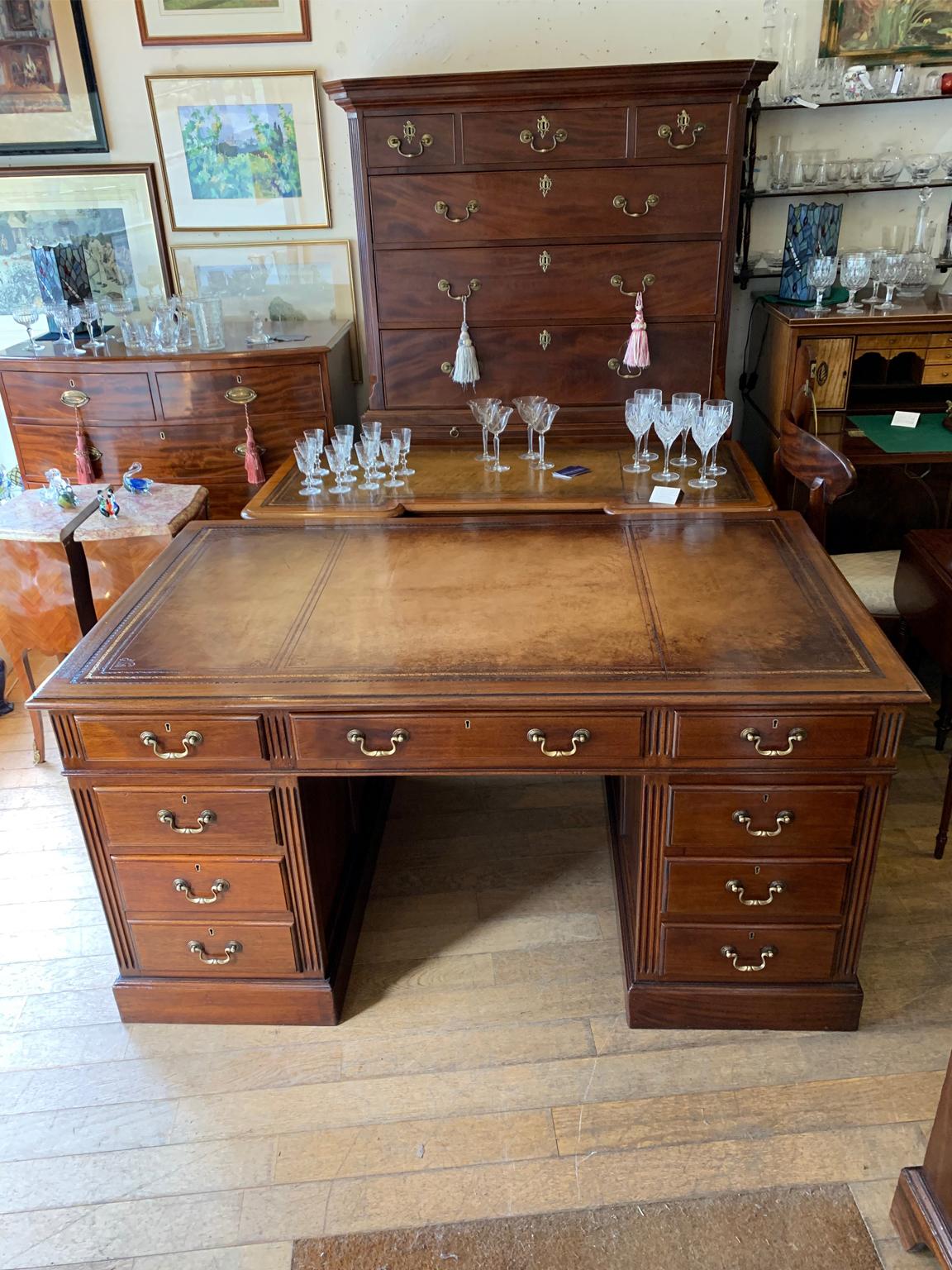 Late Edwardian / 1920’s panelled pedestal desk, the top with a leather writing surface and nine drawers all fitted with brass swan neck handles, locks and working keys. Comes apart in three separate sections
