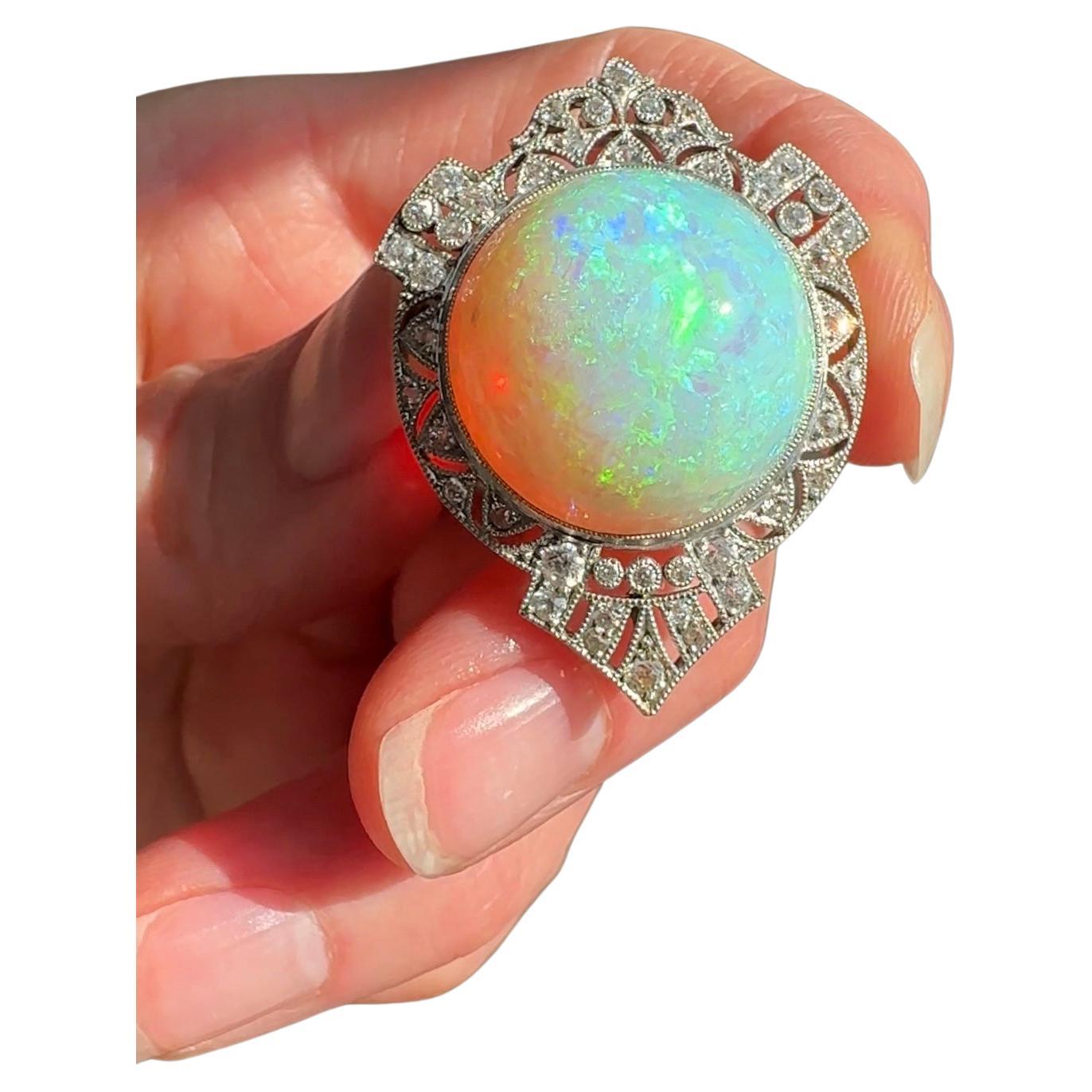 Dating to the first or second decade of the twentieth century, this delightful pendant brooch by Black, Starr and Frost centers on a magical 25 carat opal gumball filled with a dazzling array of colors. Flecks of neon green, lilac purple and
