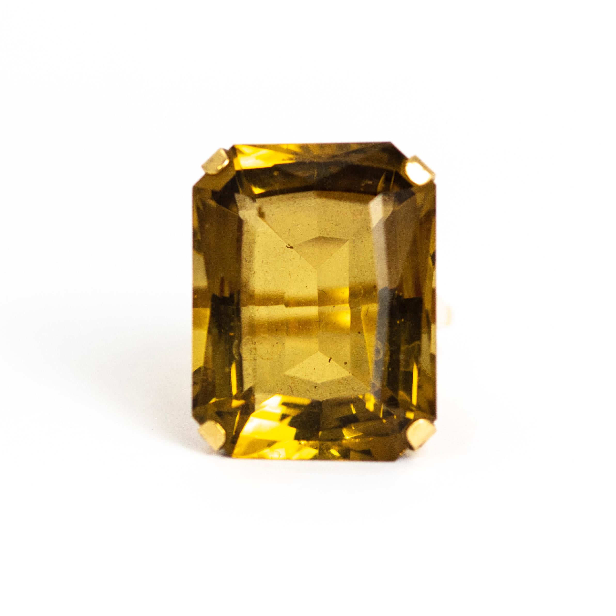 The glistening citrine in this ring is deep in colour and huge! The stone sits on top of a tall openwork setting which is quite geometric on style and the band is quite delicate for the size of the ring but works perfectly. Made in London, England.