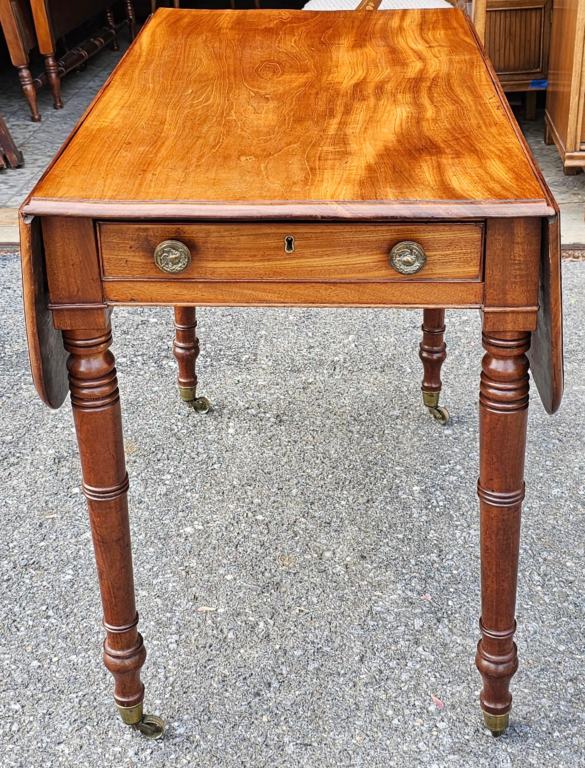 Late Federal Mixed Fruitwood Single Drawer Dropleaf Pembroke Table on wheels. The back of the table look exactly as the front, fully finished with a faux drawer. Large enough to be used as card table, breakfast table, etc..Measures 39