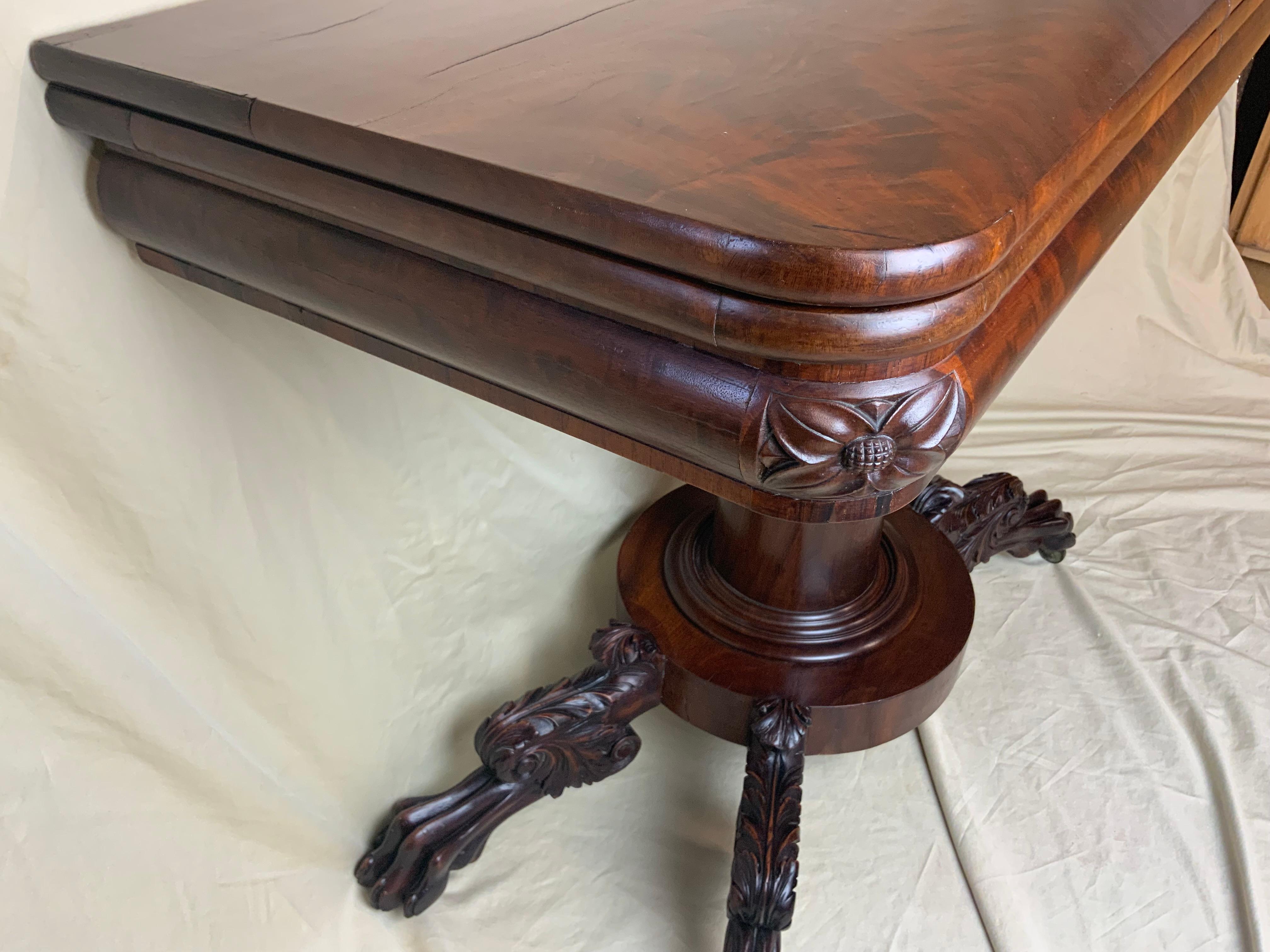 Very fine Late Federal Mahogany and Rosewood paw foot card table. Nicely figured and book matched Mahogany tops that lay nice and flat over a Mahogany and Rosewood banded frieze with carved corners. The elongated finely carved paw feet are in