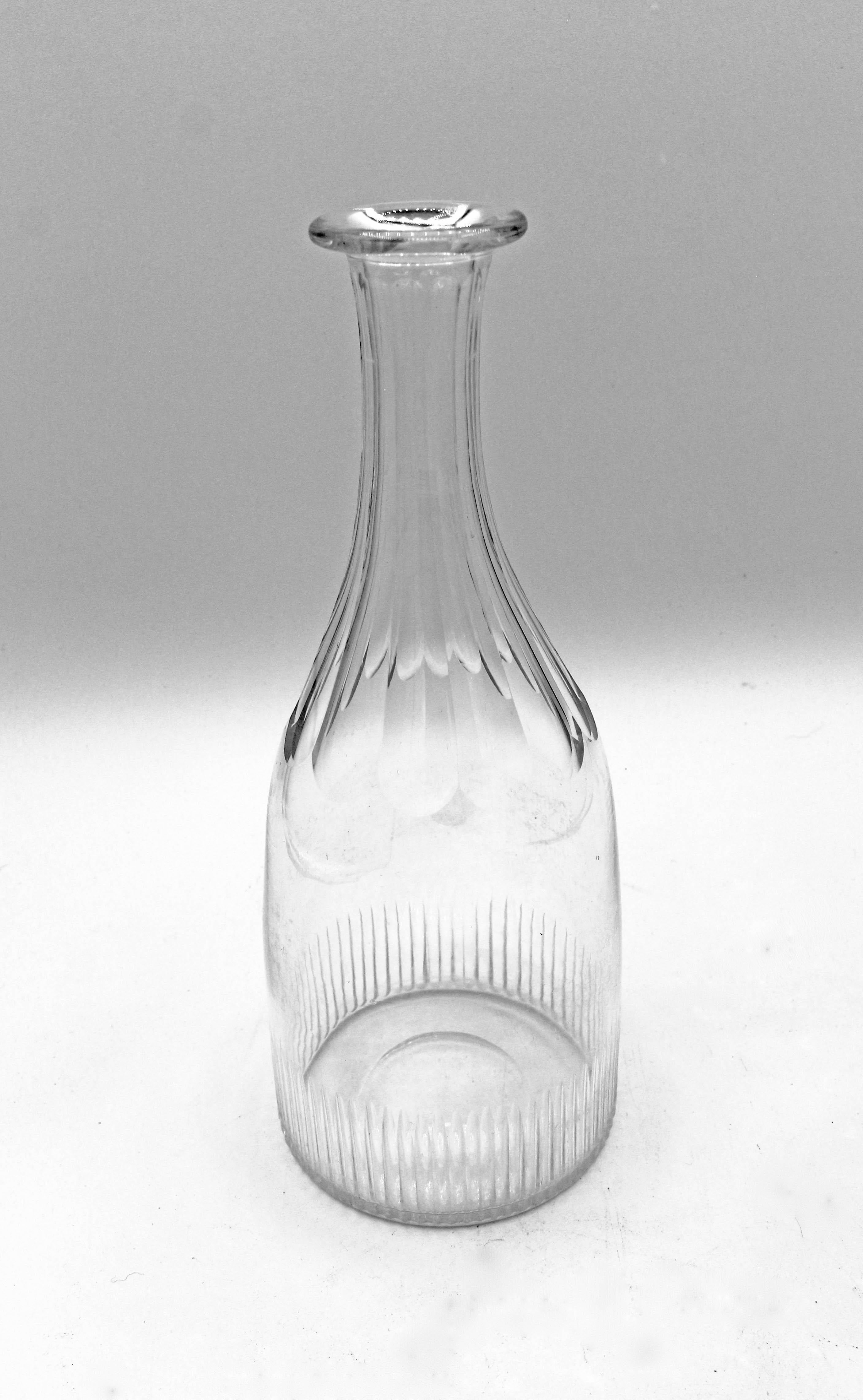A pair of decanters with original stoppers. Late George III, circa 1800. Rib and panel cut. #10 and #19 from blowing marks. Minor nibbles to stoppers. 12