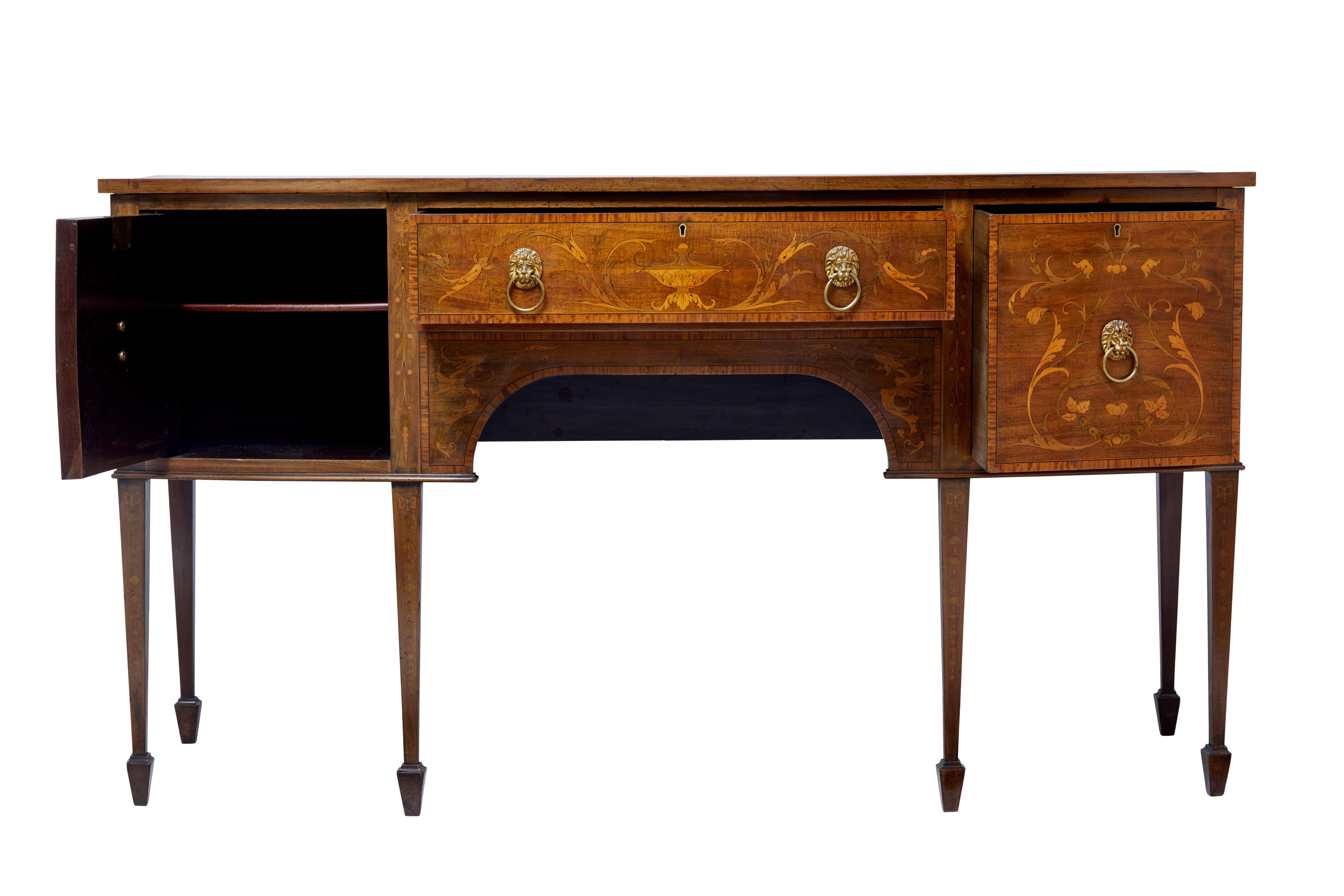 Good quality George III inlaid sideboard, circa 1810.

Doors and legs beautifully inlaid, crossbanded and strung. With brass lion mask handles.

Single drawer to the front, flanked by a deep drawer to the right and a single door cupboard with