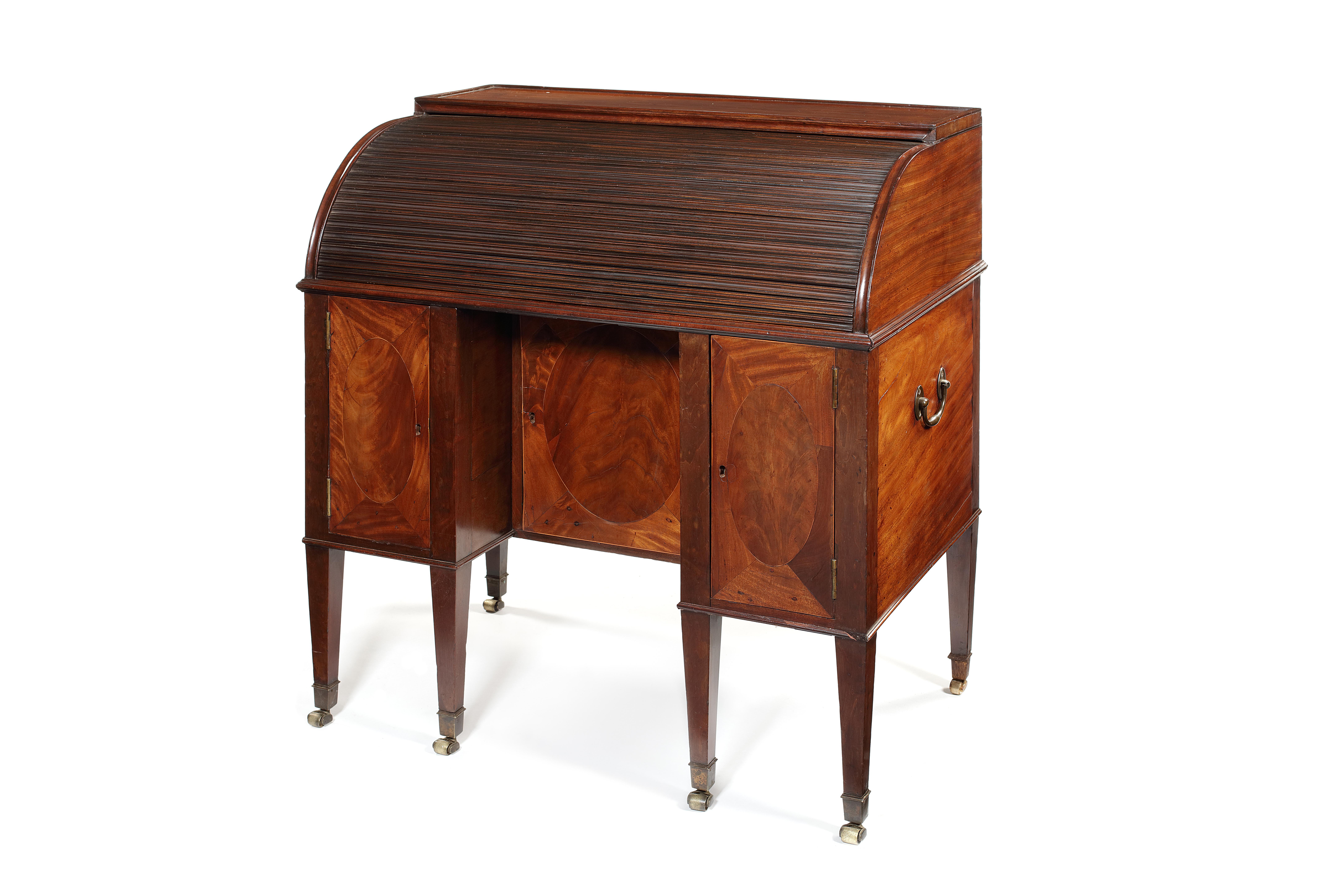 A late George III mahogany tambour desk
Inlaid with boxwood and ebonized lines, the rectangular paneled top above a tambour, enclosing a later red leather tooled writing surface, six slender pigeonholes, six pigeonholes and four short drawers above
