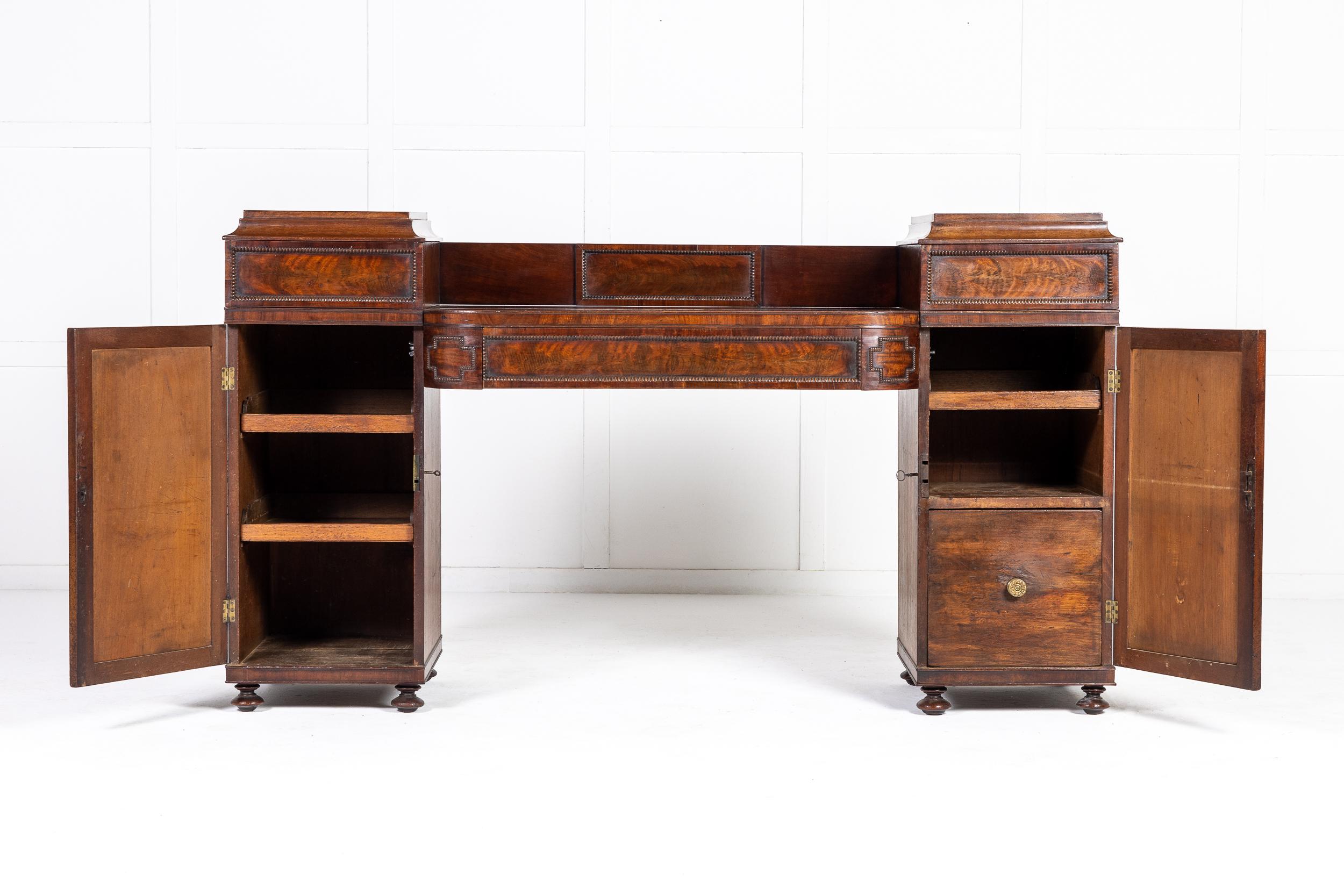 A late George IV/early William IV mahogany pedestal sideboard in the Regency classical taste in the manner of gillows c.1830
Of finely figured mahogany with panelled detailing and carved beaded mouldings. These mouldings are typical of those used by