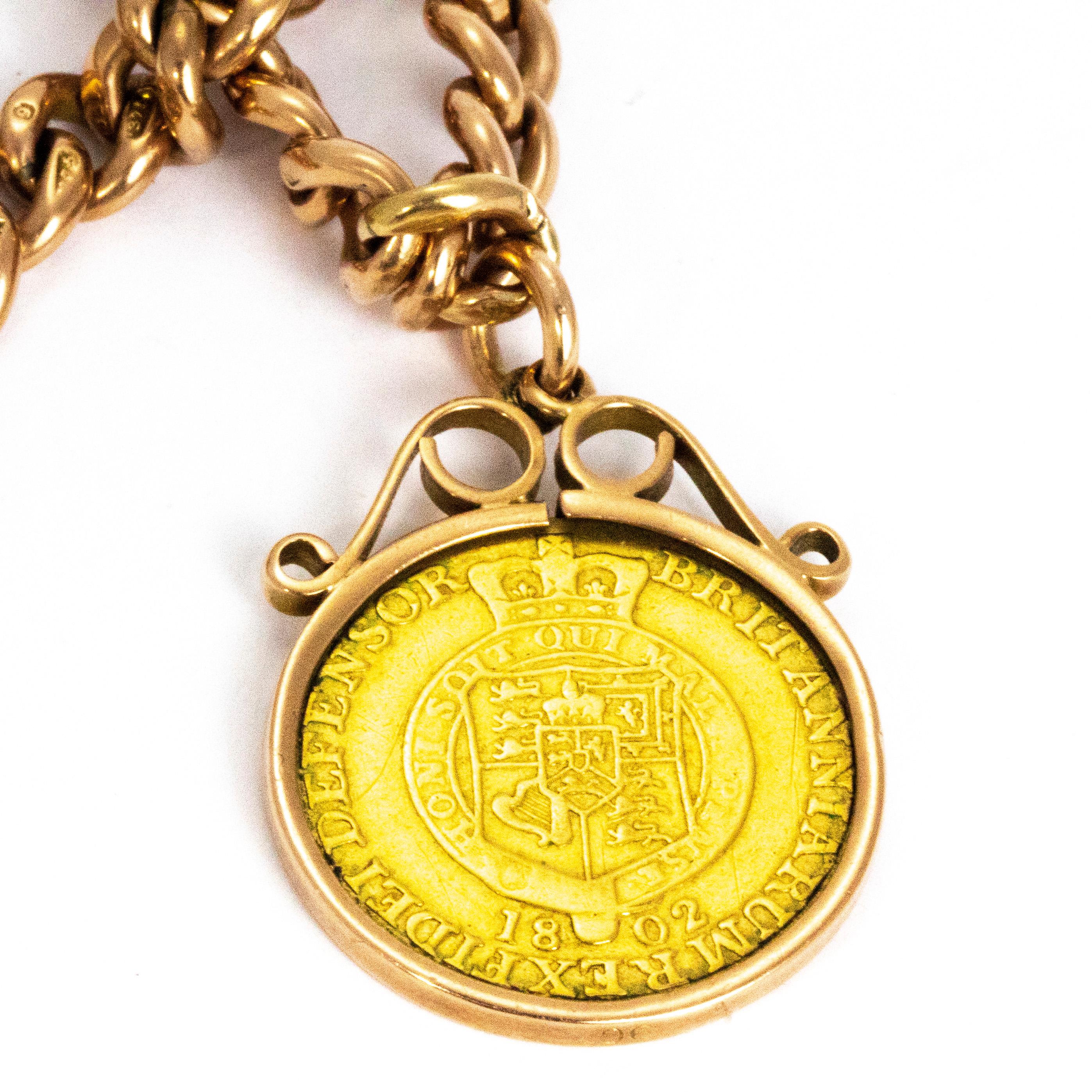 This gorgeous 9ct gold chain holds a sweet 1/2 guinea coin encased in a decorative swirl detailed surround. The chain is chunky and has a lovely weight to it. The albert necklace fastens using two swivel dog clips. 

Chain Length: 16inches 
Pendant