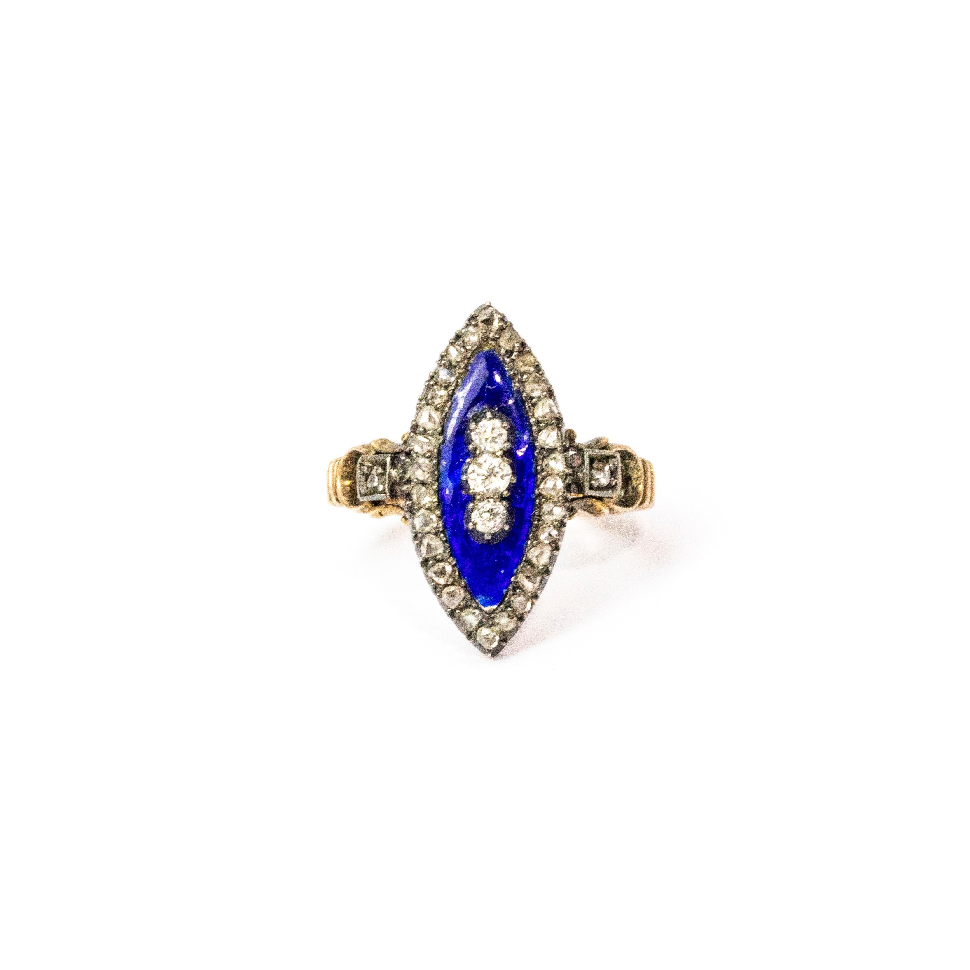 A superb late Georgian ring crafted circa 1830. The navette panel is blue enamel set with a trip of fine white diamonds stacked at its centre, with more beautiful diamonds around its edges and extending across the rings shoulders. Wonderfully formed