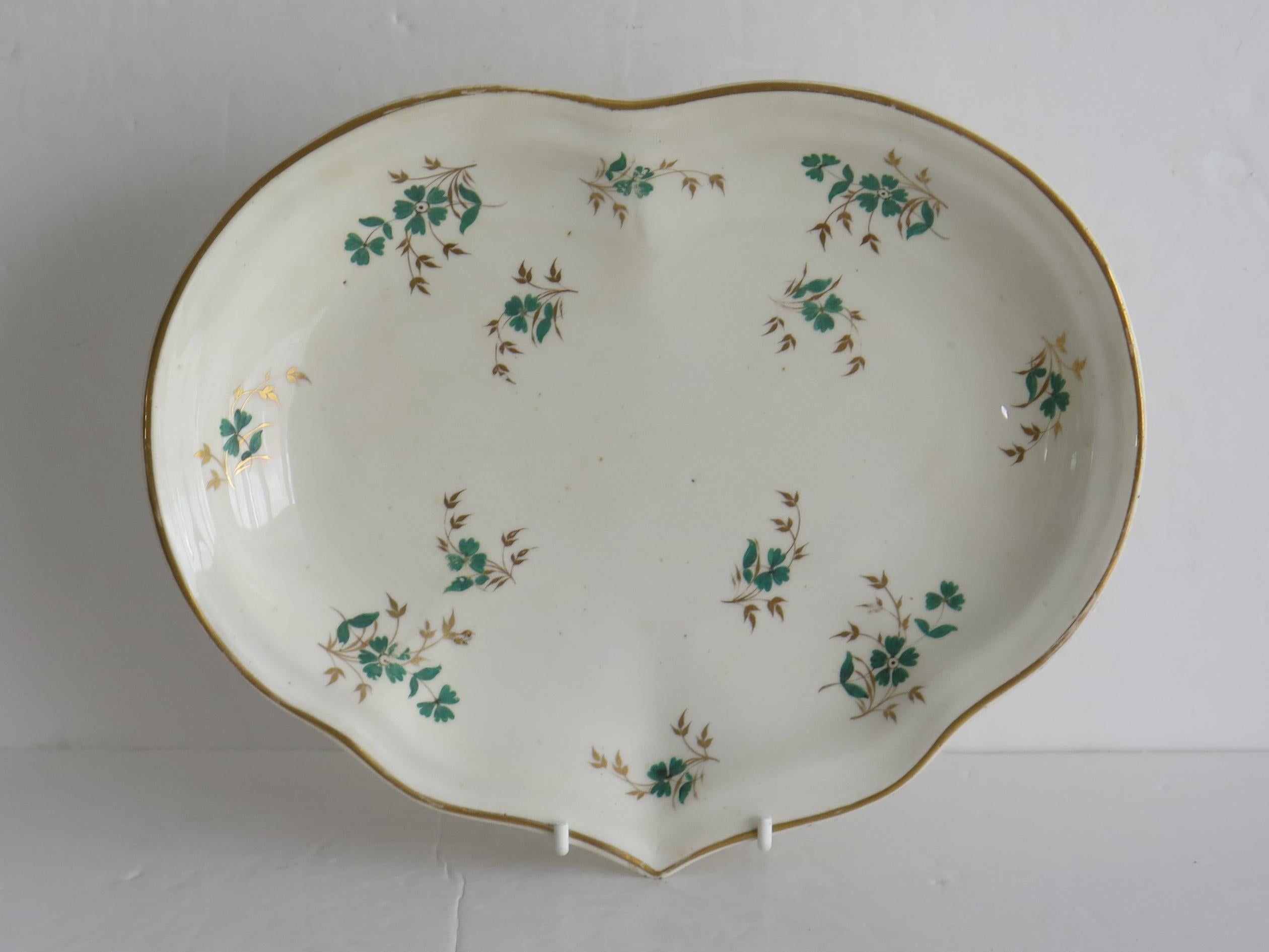 This is a beautiful porcelain heart shaped Desert dish, hand painted and gilded in a sprig pattern, made by the Derby factory, in the late Georgian period, circa 1825.
 
This dish has been hand decorated in a French influenced 