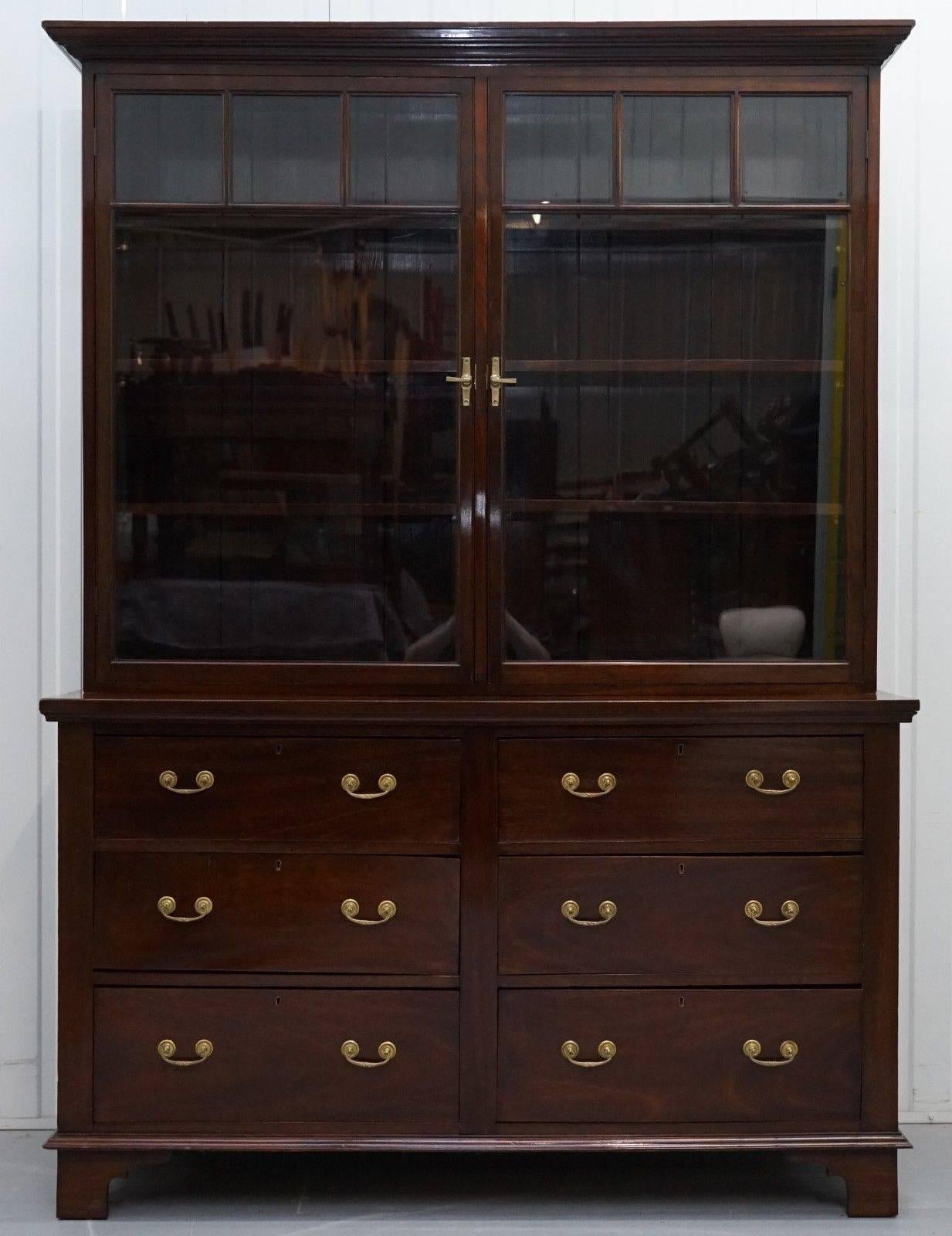 We are delighted to offer for sale this lovely handmade in England solid mahogany library bookcase cabinet.

A very good looking and well-made piece in period condition, the glass and all timber is original, the wood has warped on one or two of