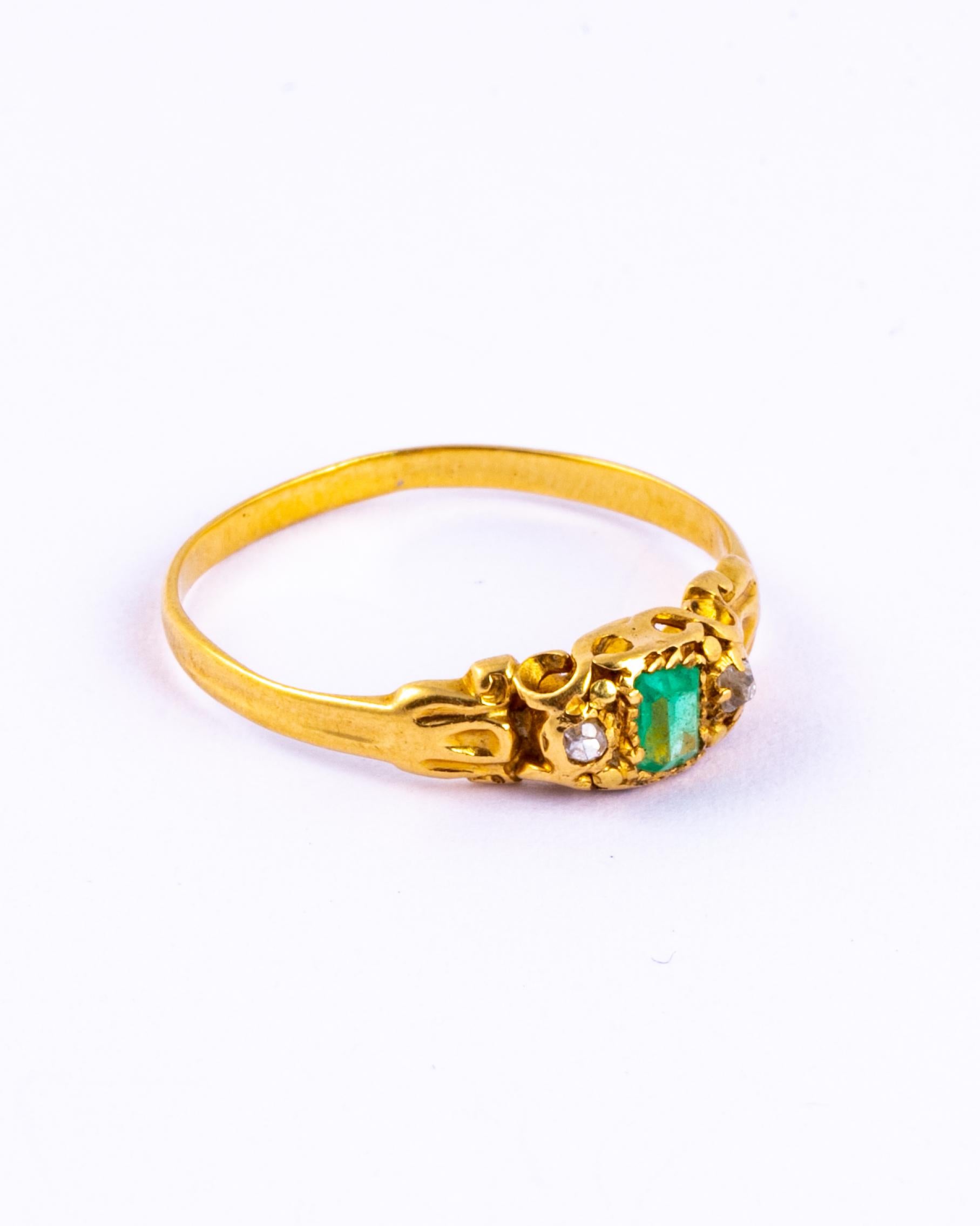 This ring boasts fine detail. A shimmering old mine cut diamond sits either side of a bright emerald. The setting itself is stunning, there is swirl detail, dotting detail, chain detail and all of this surrounds the gorgeous stones. Modelled in