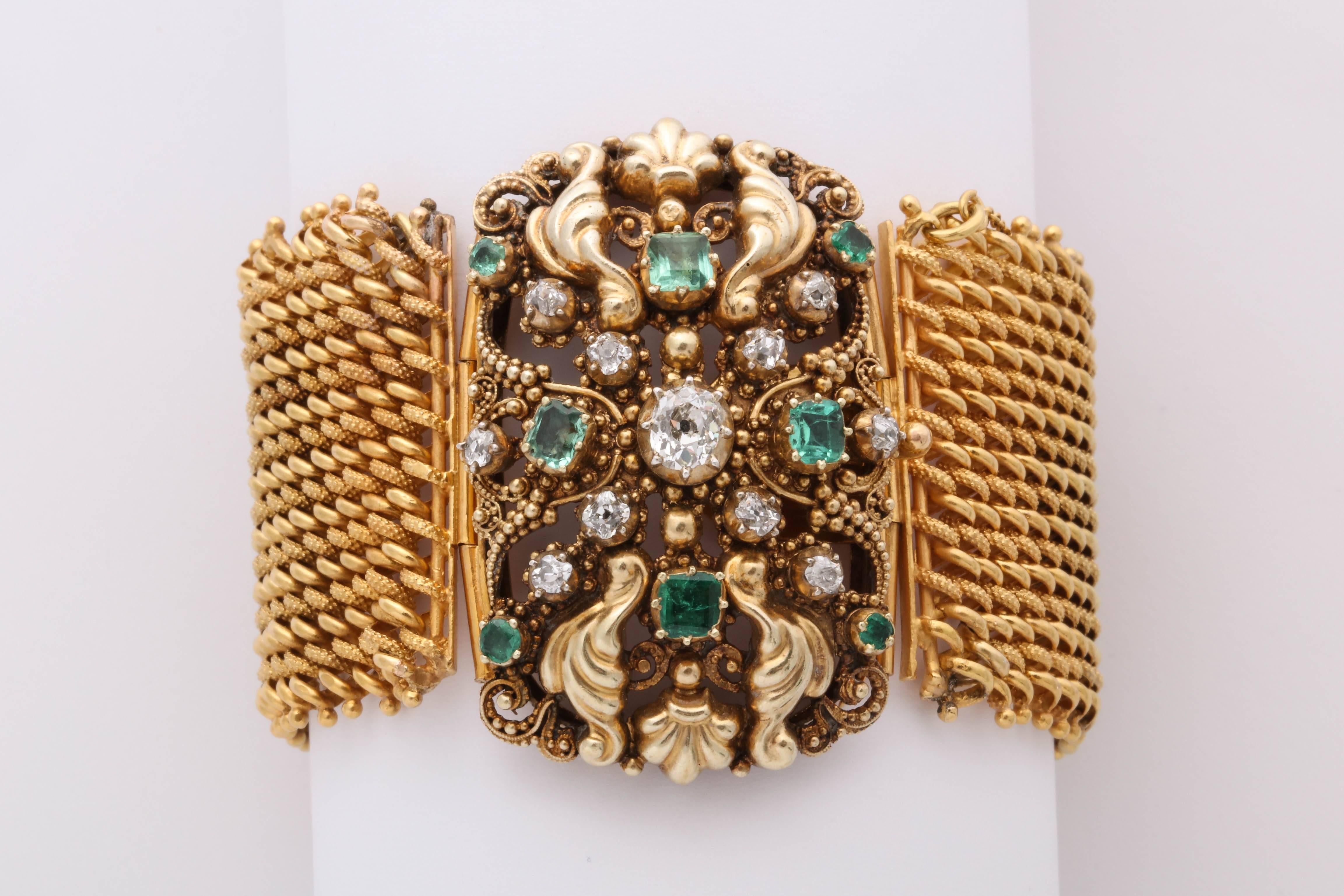 Yellow gold chain bracelet with a beautiful large clasp set with diamonds and emeralds. 