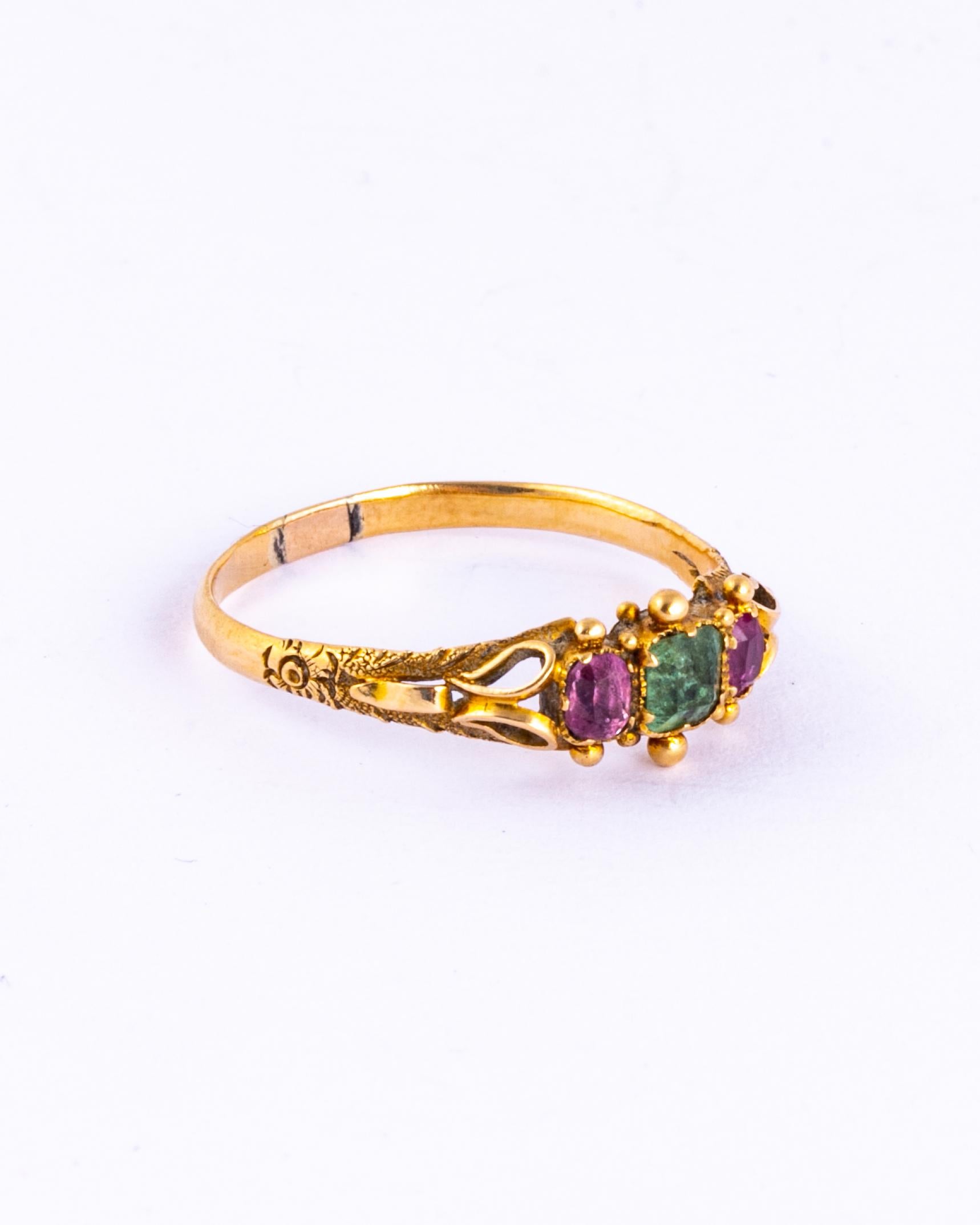 This little stunner holds a pale green emerald and the centre and either side of this central stone is a ruby. The emerald measures approx 25pts and the rubies total approx 20pts. The ring is modelled in 18ct gold.

Ring Size: O 1/2 or 7 1/2 
Band