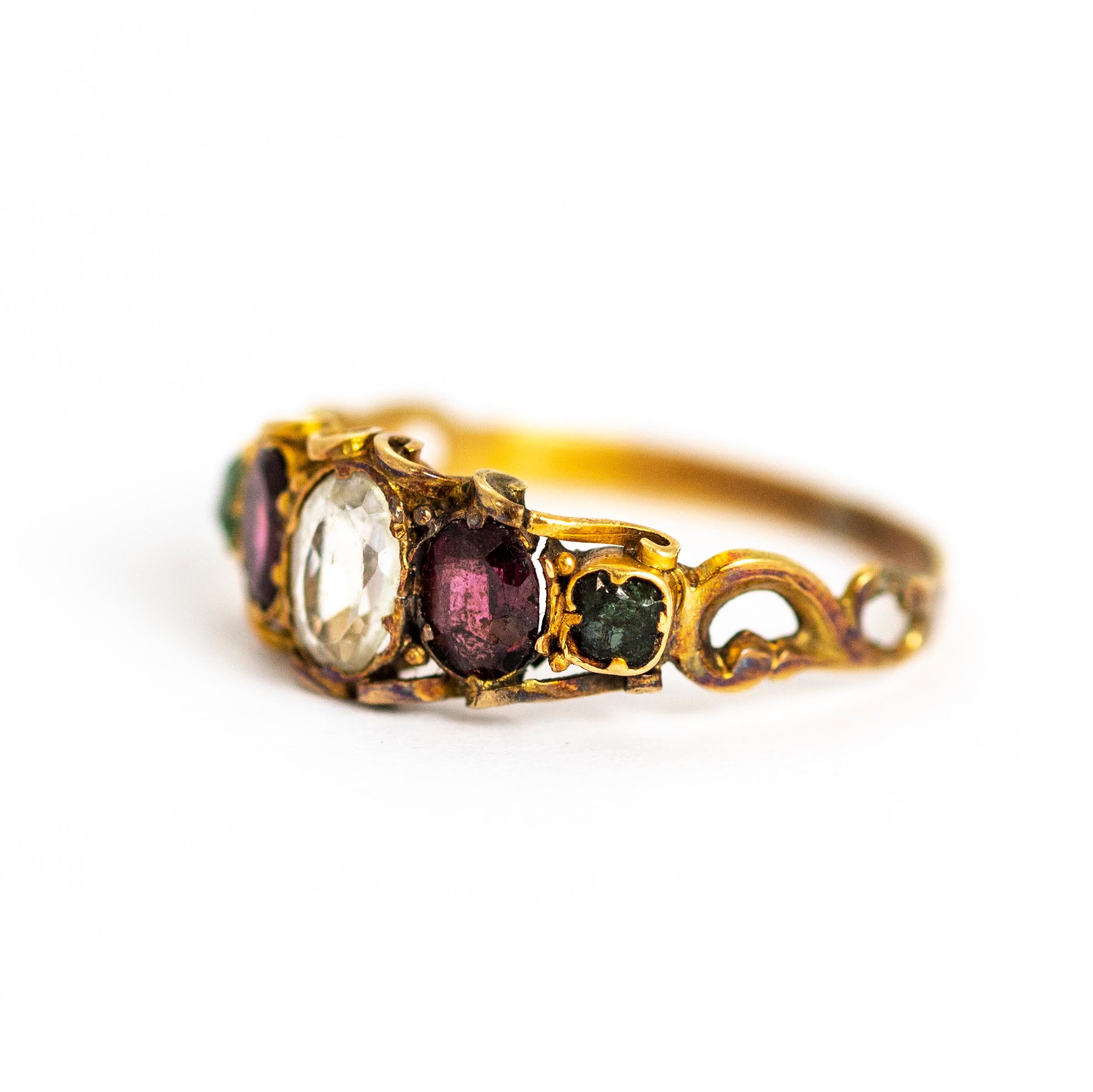 The bright chrysoberyl next to the deep amethyst and stunning green emerald are all held in a beautiful and intricate scroll setting modelled out of 12ct gold. The rest of the band is finely engraved and the shoulders are also beautifully
