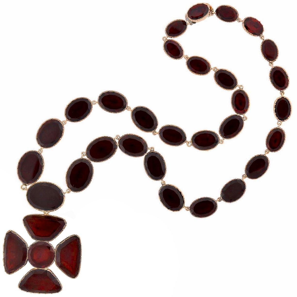 An absolutely stunning garnet necklace from the late Georgian (ca1850s) era. Crafted in rosy 18kt gold, this fantastic piece is comprised of a beautiful Maltese cross which hangs from a garnet link chain. Five garnets come together to make up the