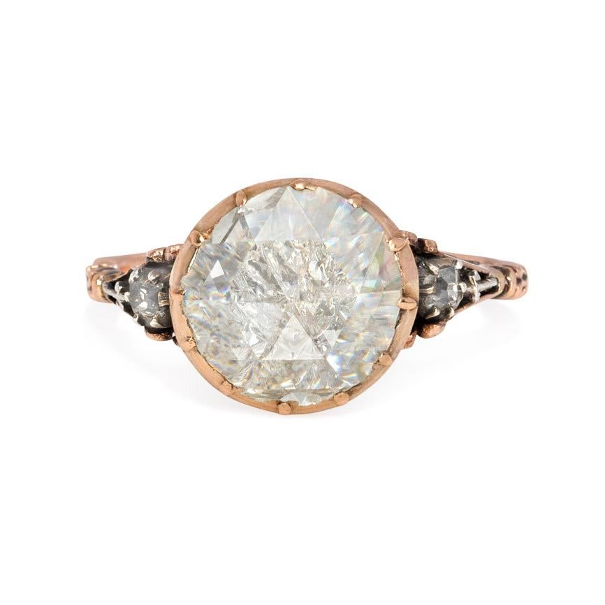 An antique gold and foiled back rose-cut diamond ring in a foliate mounting, in 15k.  England. 
Face of center diamond measures approximately 1 cm in diameter

Current size: 7 (Please contact us with re-sizing questions.)