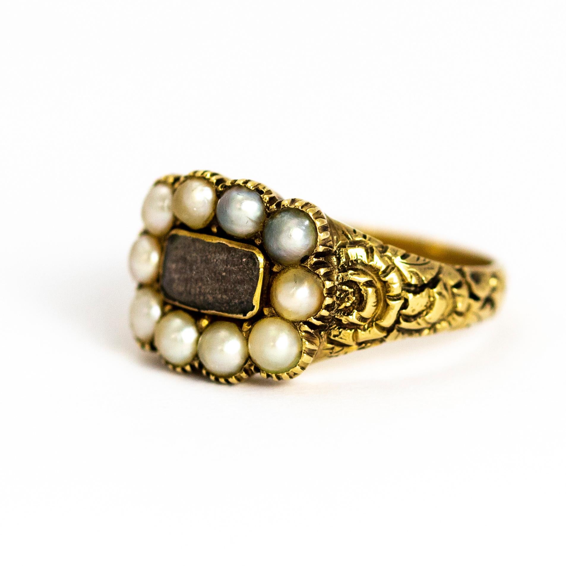 This lovely example of a late Georgian mourning ring holds a weave of hair behind crystal which sits on the most beautiful shoulders. The shoulders feature a raised flower pattern and the ring is modelled out of 9ct gold.

Ring Size: M 1/2 or 6 1/4 
