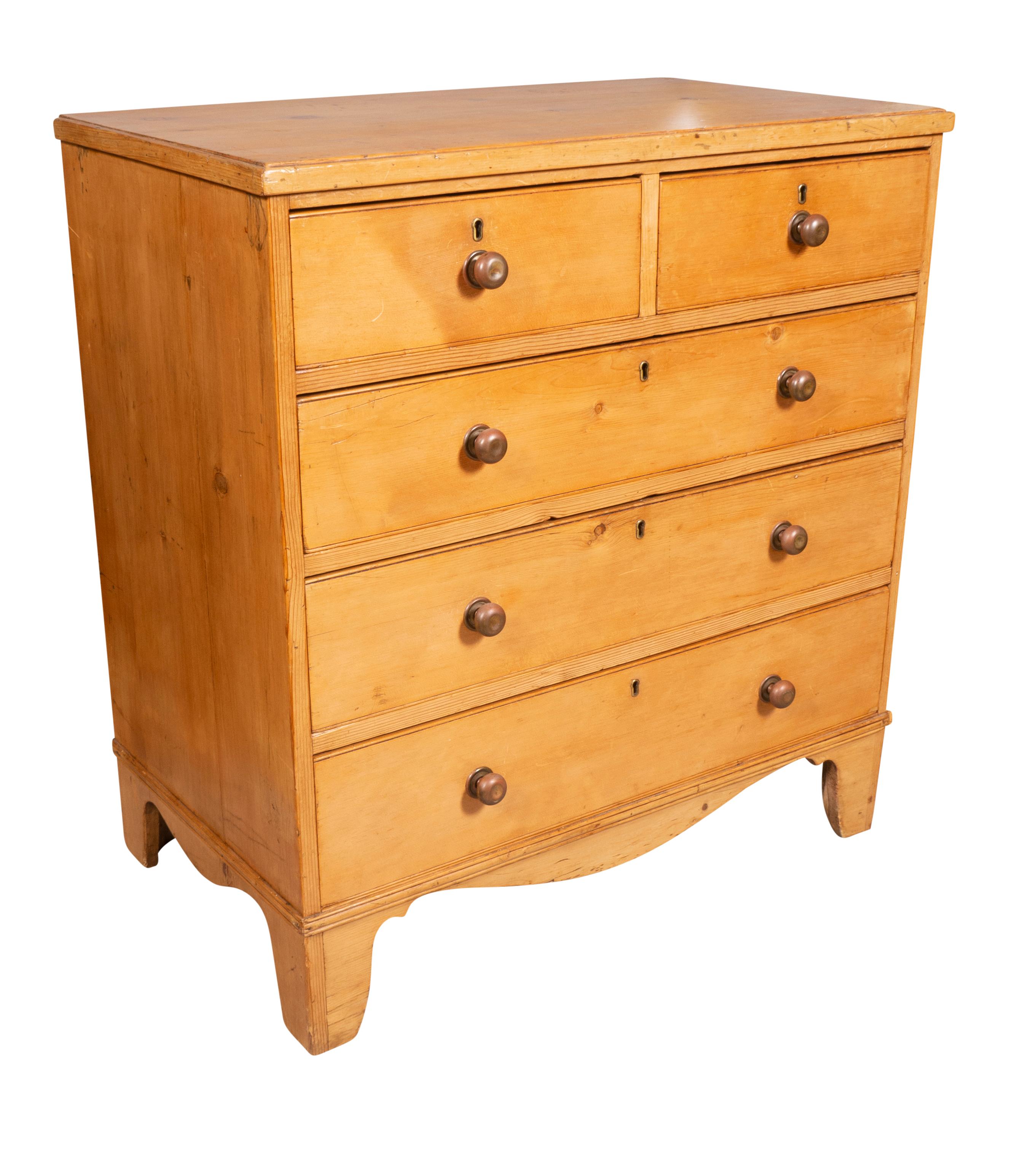 With a rectangular top over two short and three long drawers all with brass knobs. Bracket feet.