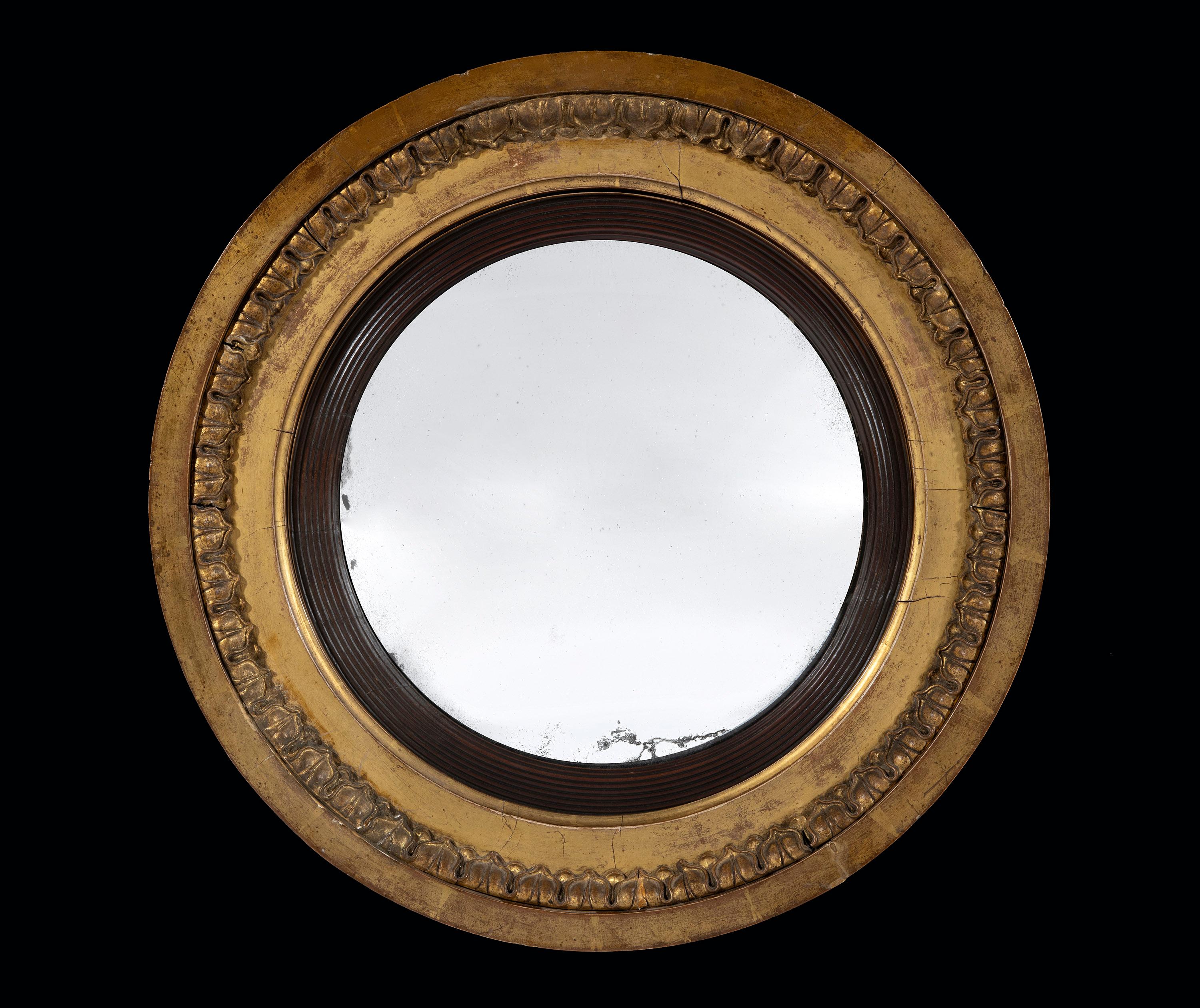 The crisply carved frame retains the original gilding. The convex plate is original.