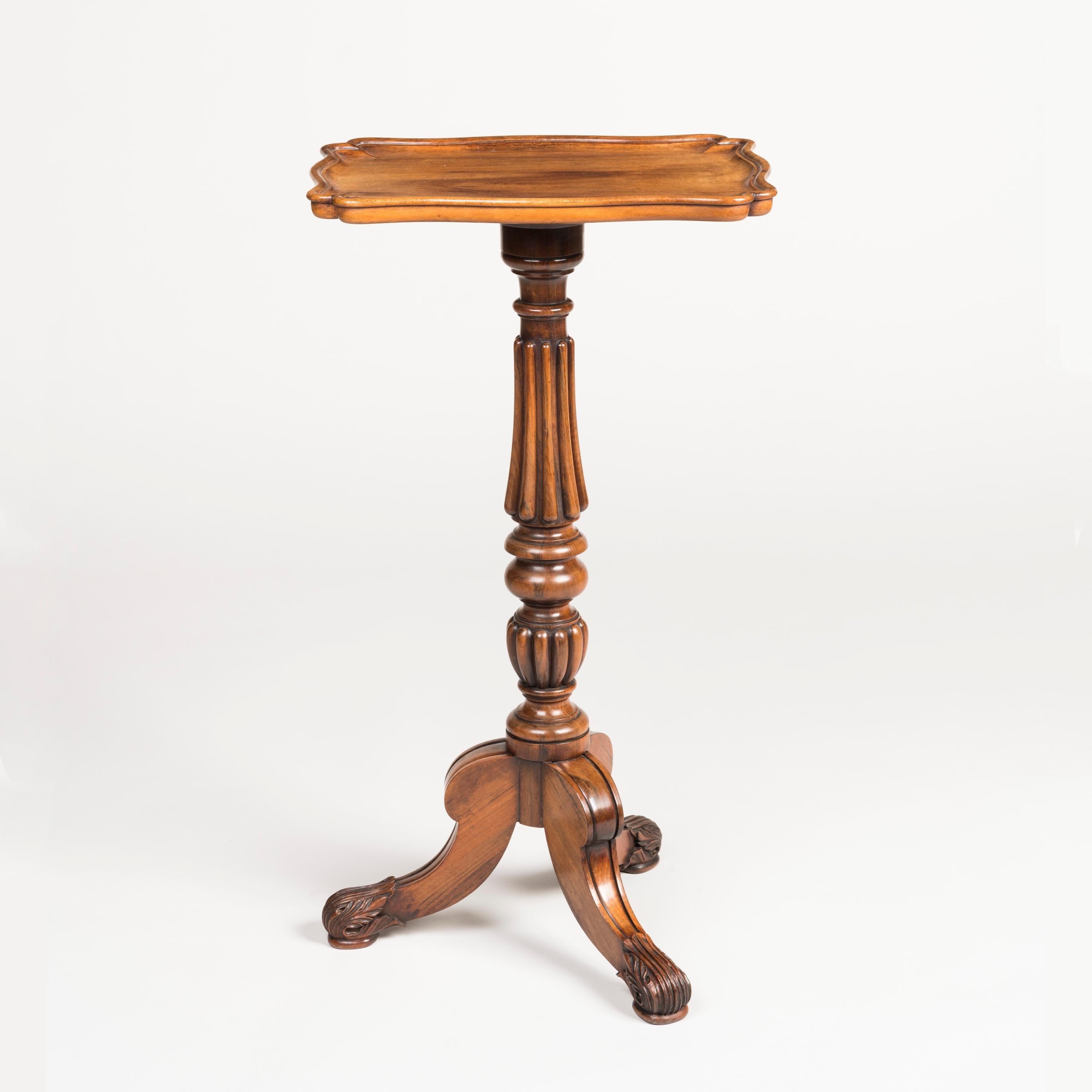 A Late Georgian Tripod Table

Constructed from well-figured rosewood, rising from tripod scrolled feet, in the Grecian taste, with lobed and ring-turned central stem supporting a moulded rectangular dished top.
Circa 1825.

