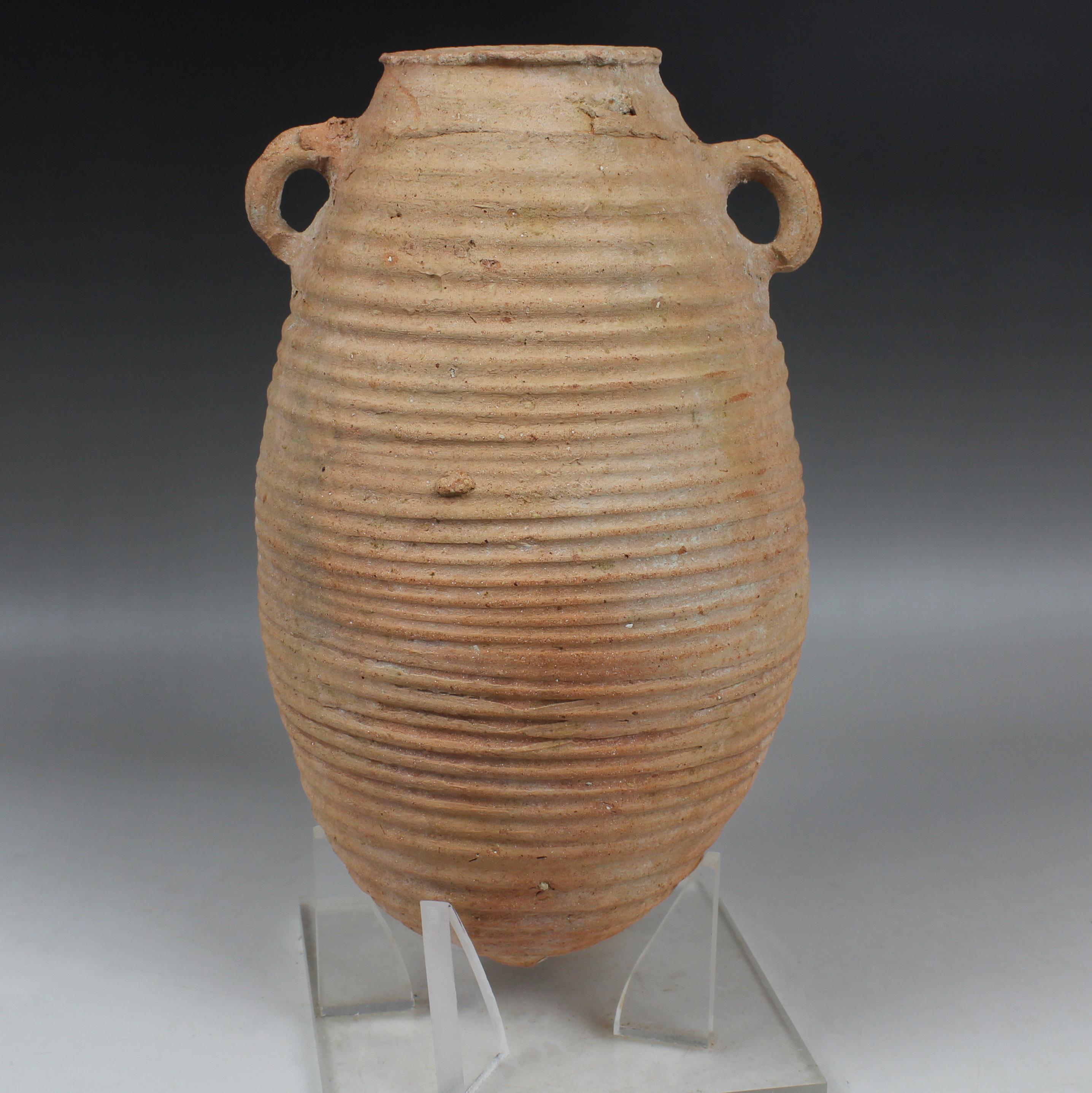 ITEM: Amphora, Type Proto-Gazan
MATERIAL: Pottery
CULTURE: Late Hellenistic / Early Roman
PERIOD: 1st Century B.C – 1st Century A.D
DIMENSIONS: 290 mm x 165 mm (without stand)
CONDITION: Good condition. Includes stand
PROVENANCE: Ex Emeritus
