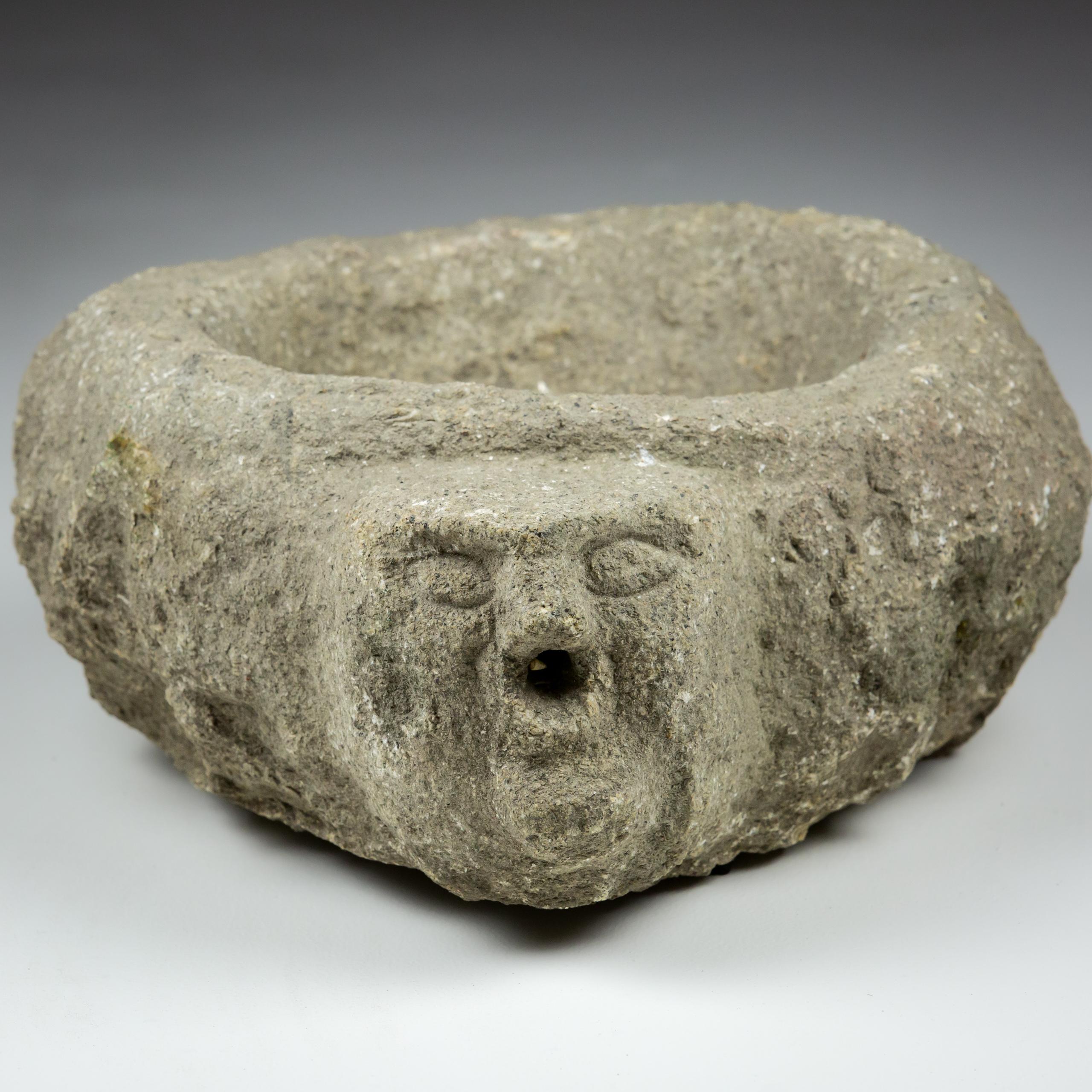 Carved granite benitier or sink, primitive carved stone head as the water spout. Usually found at the entrance of Church or Monastry, to cleanse hands and mark the sign of the cross with Holy Water on their forehead prior to worship. Most likely