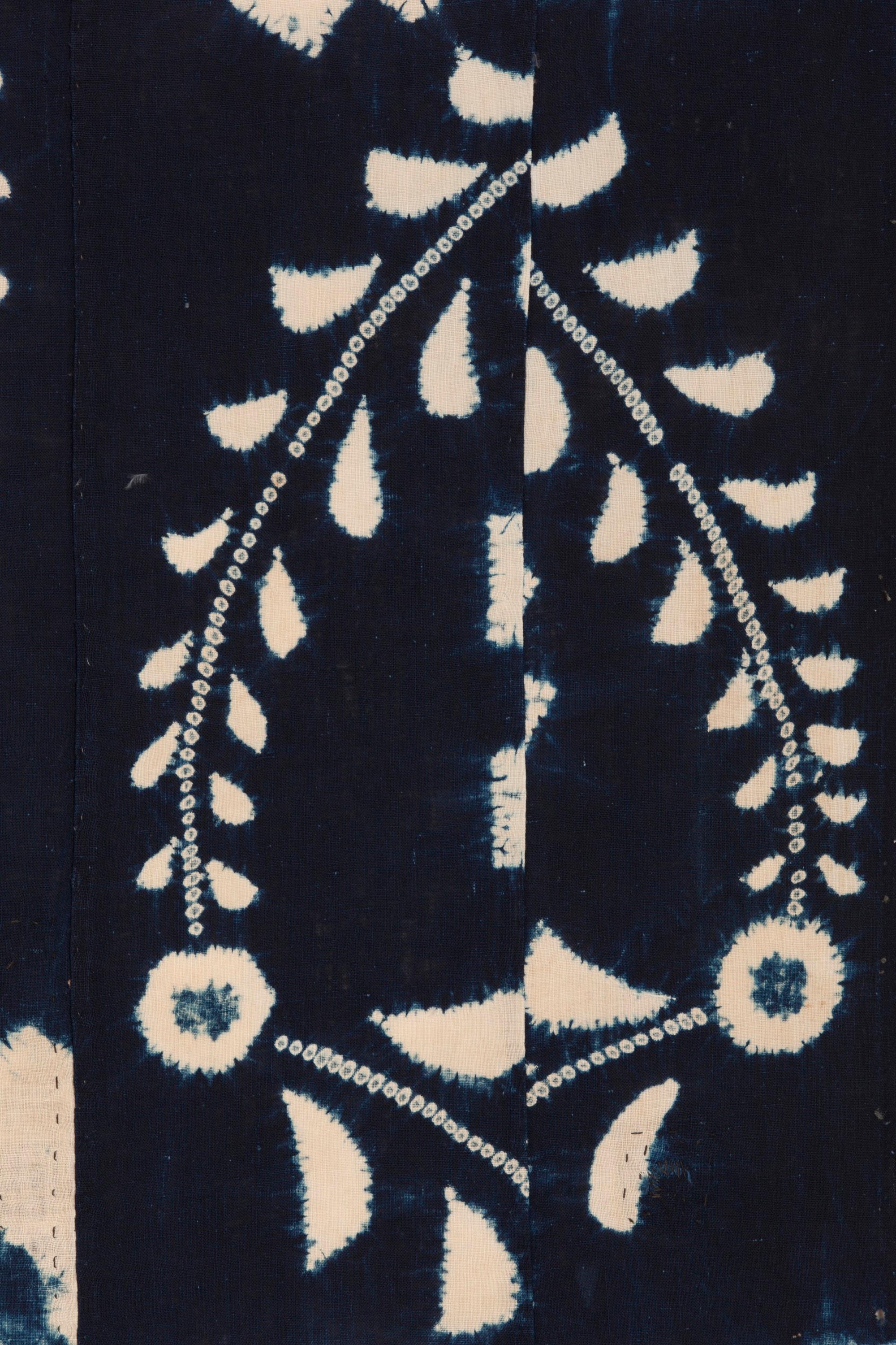 An Arimatsu indigo shibori futon cover from the late Meiji period, 3 panels wide, left and right panels are patched and darned, possibly repurposed kimono, handspun cotton, dyed using dark indigo.