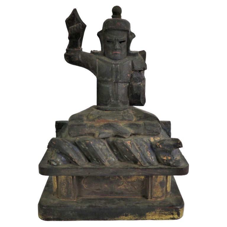 Probably more than likely from a Japanese home altar, this is a folk art rendition of Hachiman Yahata no Kani, Japanese God of War, Archery, Culture and Protector of Shrines. Made by using different pieces of wood, we can assume it was not produced