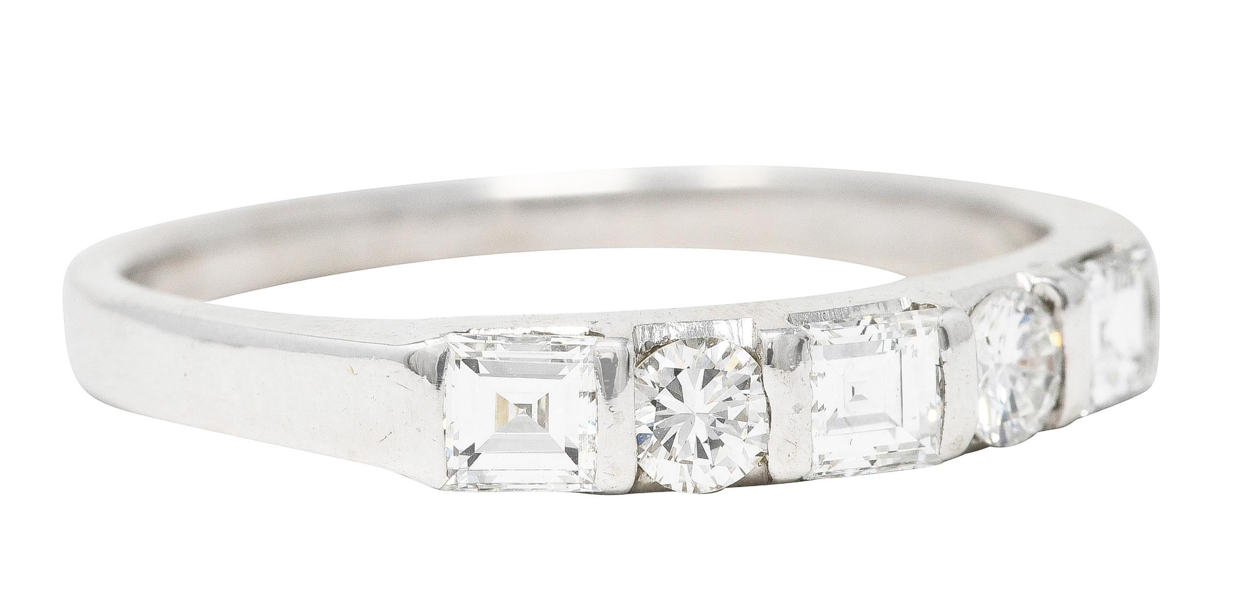 Band ring is bar set to front with diamonds. Square step cut alternating with round brilliant cuts. Weighing in total approximately 0.70 carat. With well matched G/H color and VS clarity. Stamped for platinum. Circa: 1950s. Ring Size: 8 & sizable.
