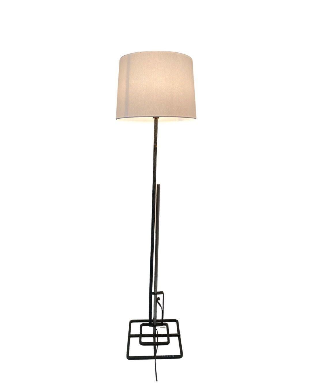 Late Mission style adjustable cast wrought iron floor lamp w replacement lamp shade included. The lamp features a square target base with polished steel and an iron center post. 
Circa 1920.
 