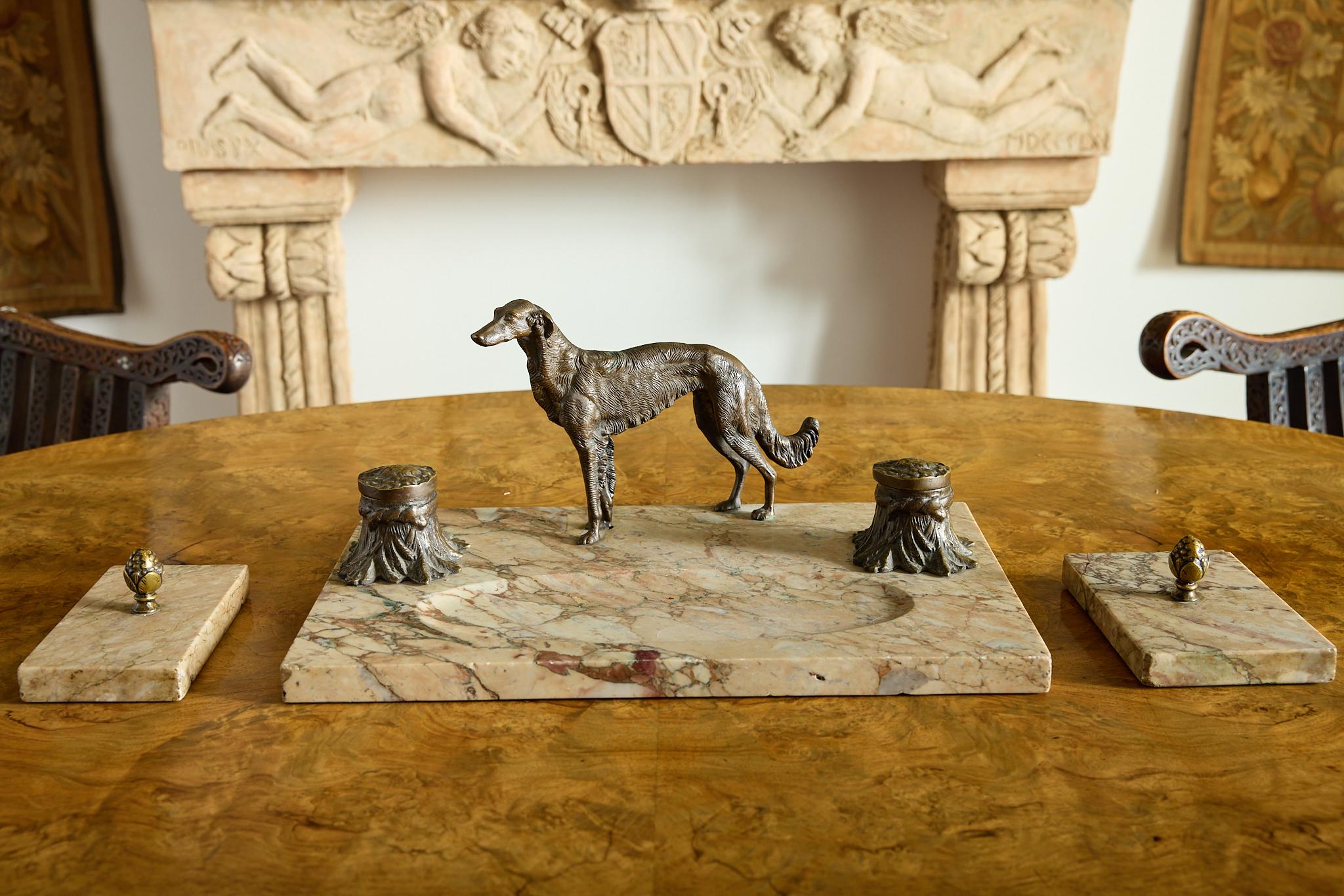 A beautiful, late 19th, early 20th century ink stand. The bronze ink pots are modelled as tree trunks mounted on a marble base with a finely modelled bronze figure of a dog in the centre. 
The set includes two marble paper weights with bronze, acorn