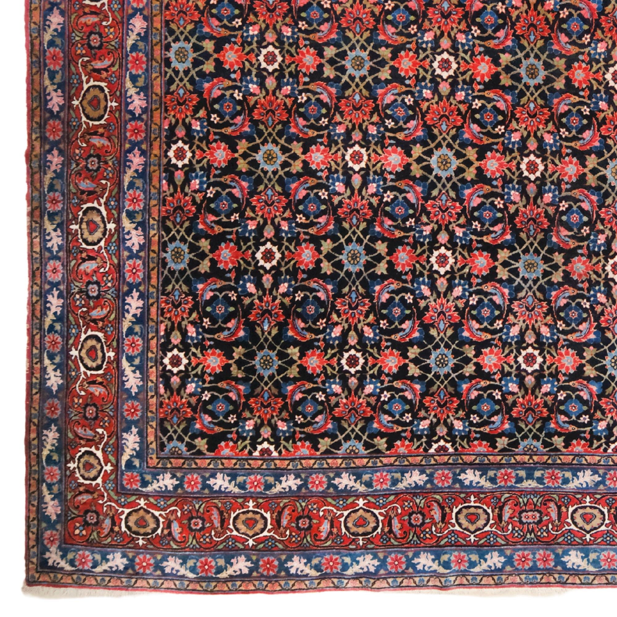 This late 19th century antique Tabriz carpet is a rare piece that represents Iran’s deep-rooted carpet weaving tradition. In perfect harmony of blue and red tones, various floral motifs and finely detailed patterns in the center elevate the