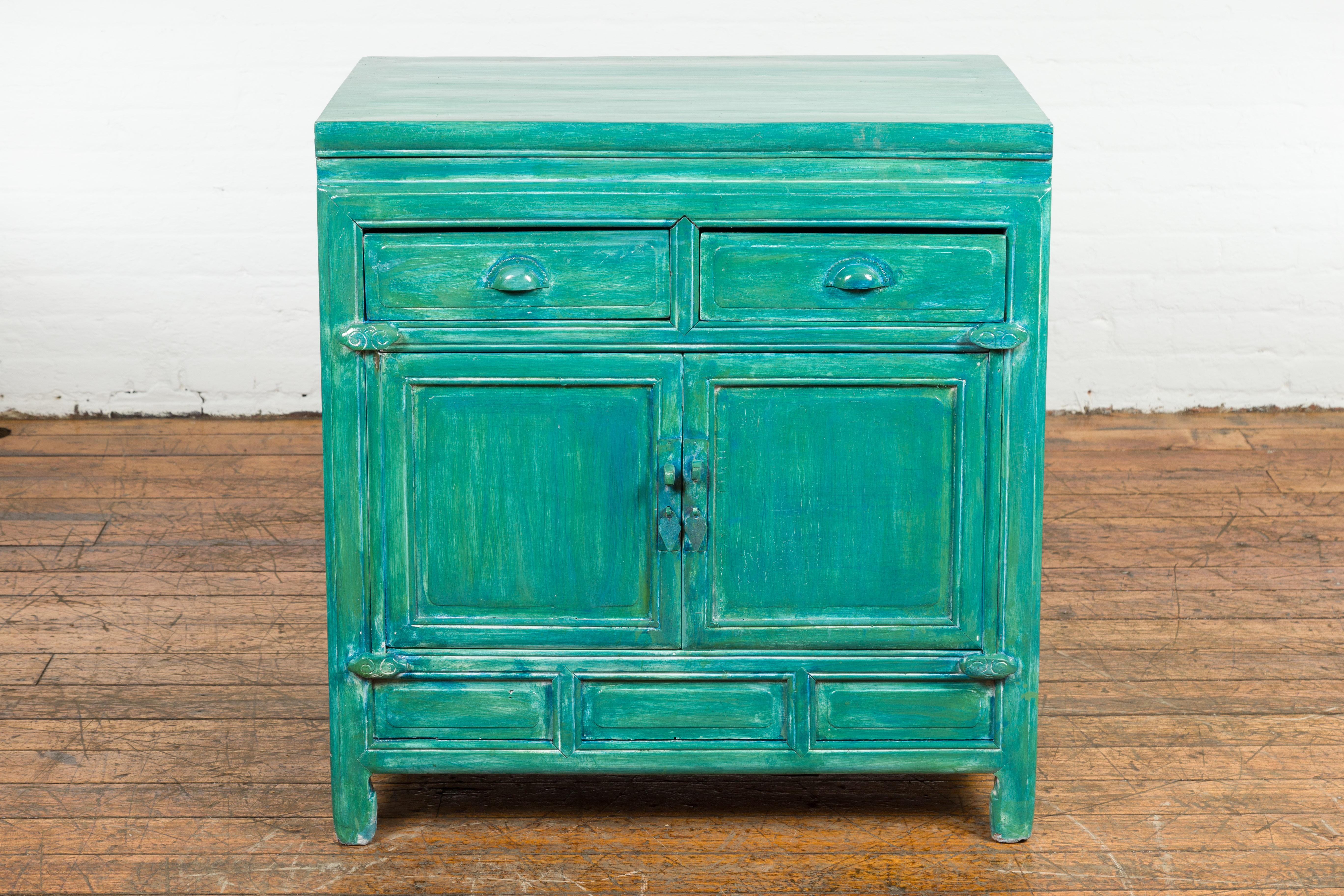 A Chinese late Qing Dynasty period side cabinet from the early 20th century, with two drawers over two doors, horse hoof feet and custom aqua teal hand painted finish. Created in China during the late Qing Dynasty period in the early years of the