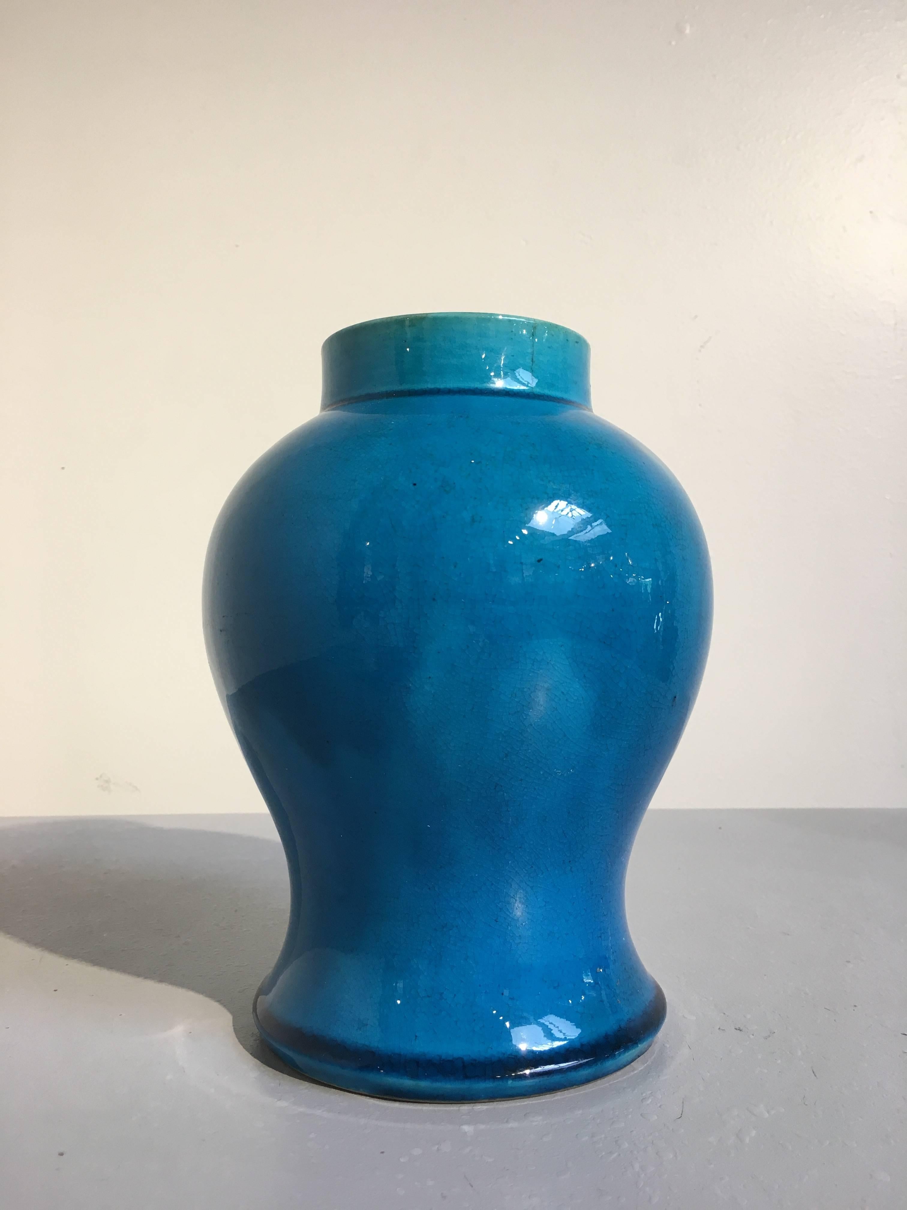 An elegant Chinese late Qing dynasty monochrome turquoise glazed baluster vase. The vase of voluptous form, with a splayed foot, narrow waist, high shoulders and short neck. The glaze of bright turquoise, pooling darker at the foot and shoulder, and