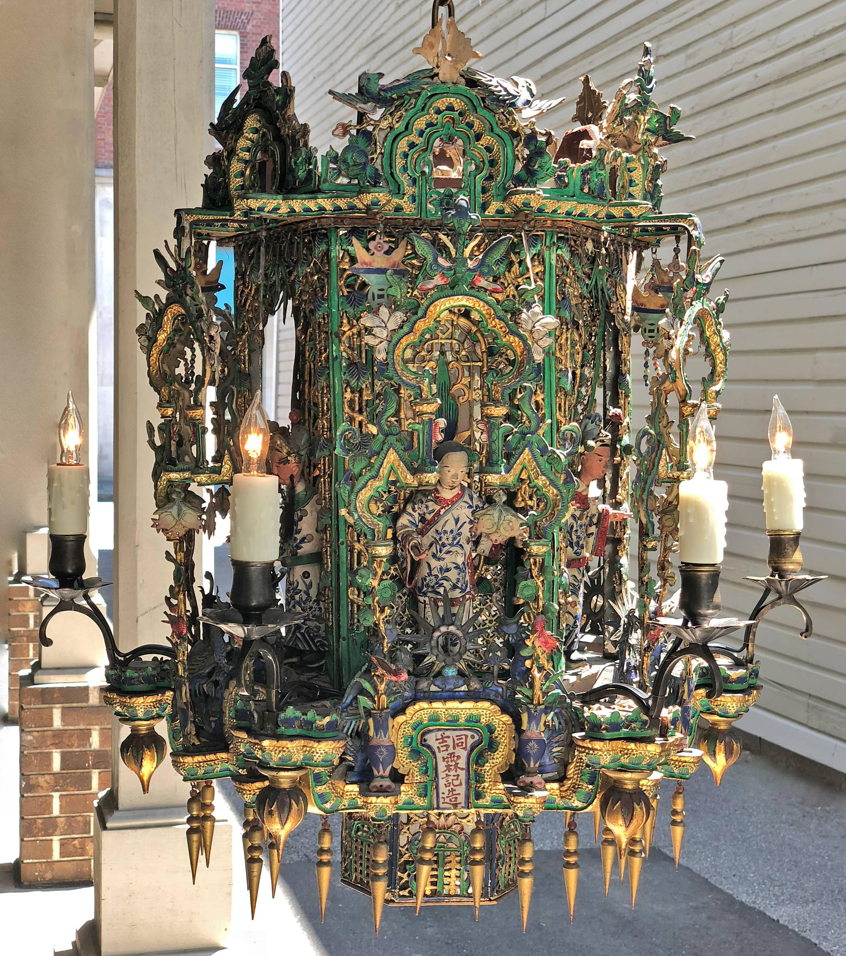 One-of-a-kind 19th century Chinese lantern made out of wood, paper mache ( Papier-mâché), mirror, brass, and cloisonne. It was originally candled but has since been rewired and electrified. 
This Asian hexagonal lantern has temple arches framing