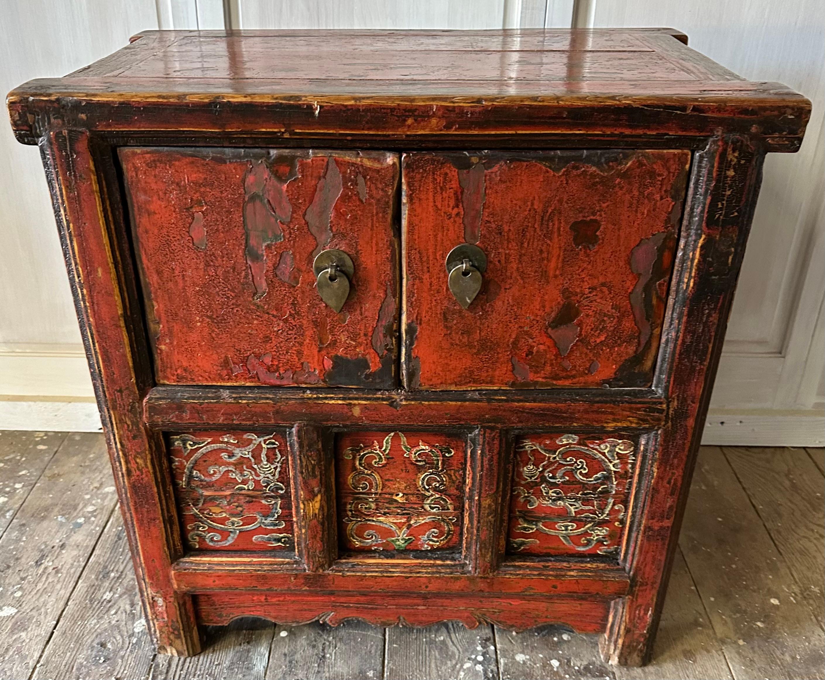Late 19th century Chinese elmwood cabinets in an old lacquered finish. This cabinet can be ideal as a bedside chest, end table next to a sofa or a cabinet in an hallway.  it  has two doors that opens up to a large deep interior cavity.
This cabinet