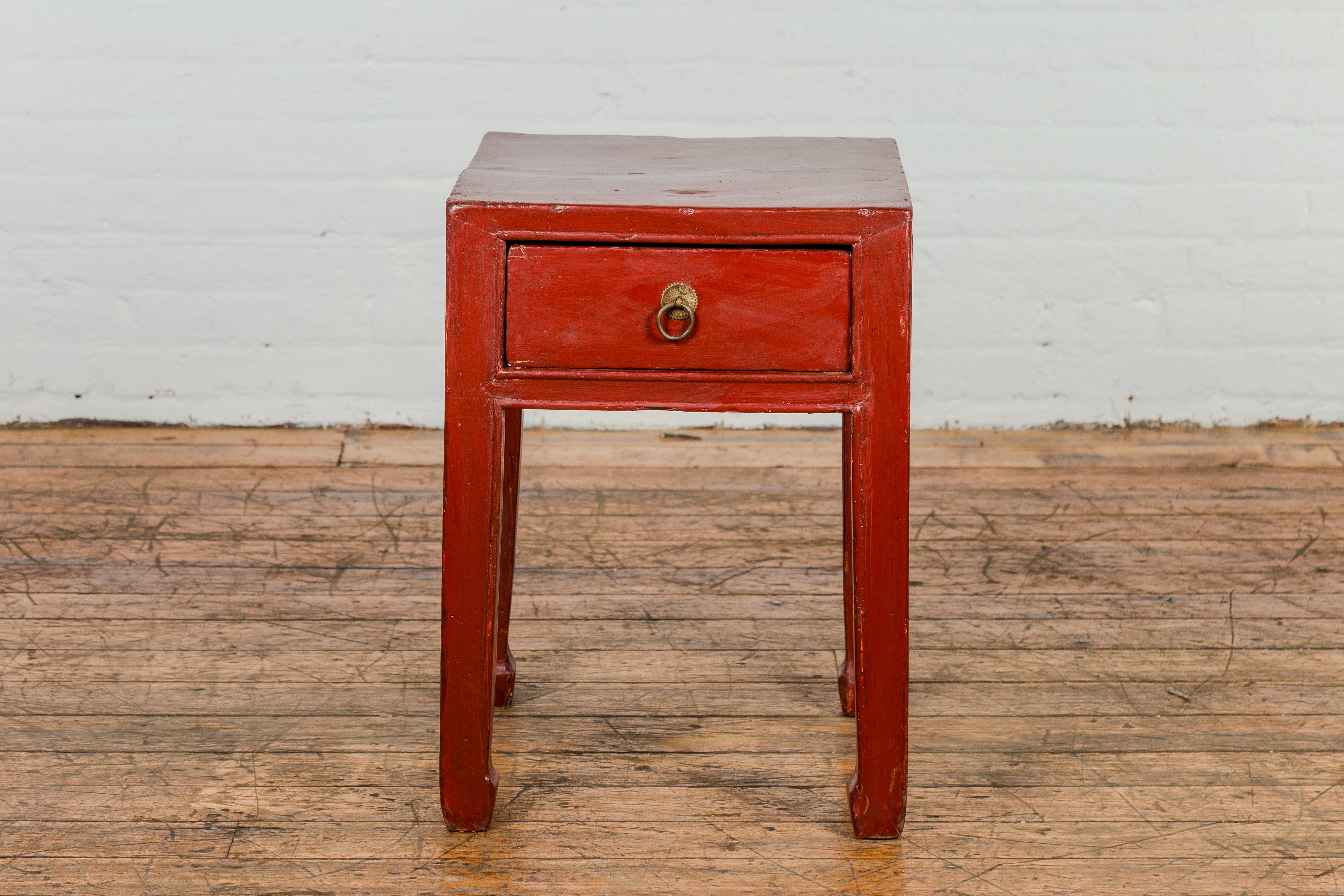 A late Qing Dynasty period red lacquer wooden side table from the early 20th century with single drawer and horse hoof feet. This late Qing Dynasty period side table dates back to the early 20th century and is steeped in rich Chinese history. The