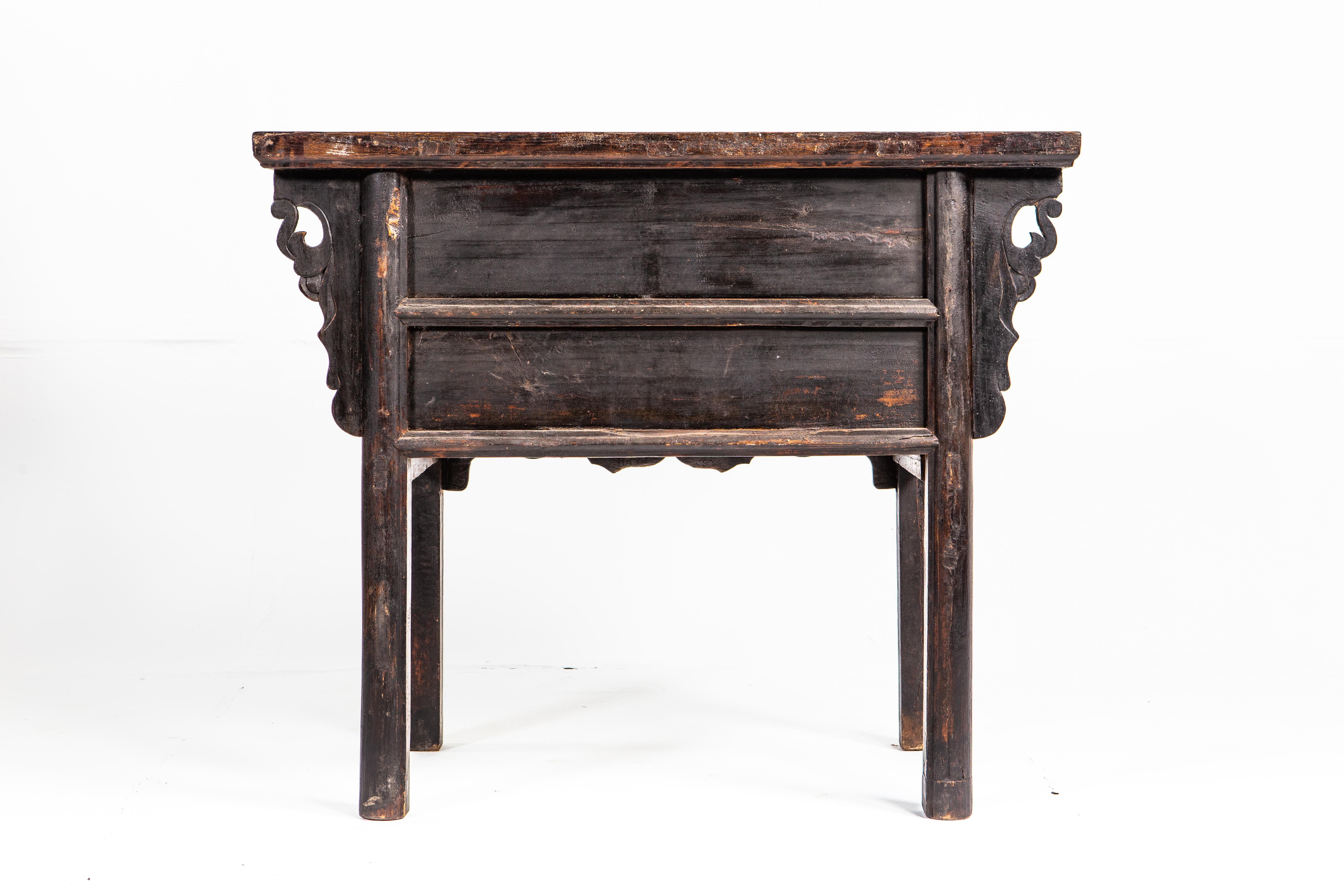This handsome Chinese side chest is from Shanxi Province, China and made from elm wood. The piece features two drawers with intricately hard-carved drawer fronts depicting birds, deer, and foliage. The hidden storage compartment below is accessible