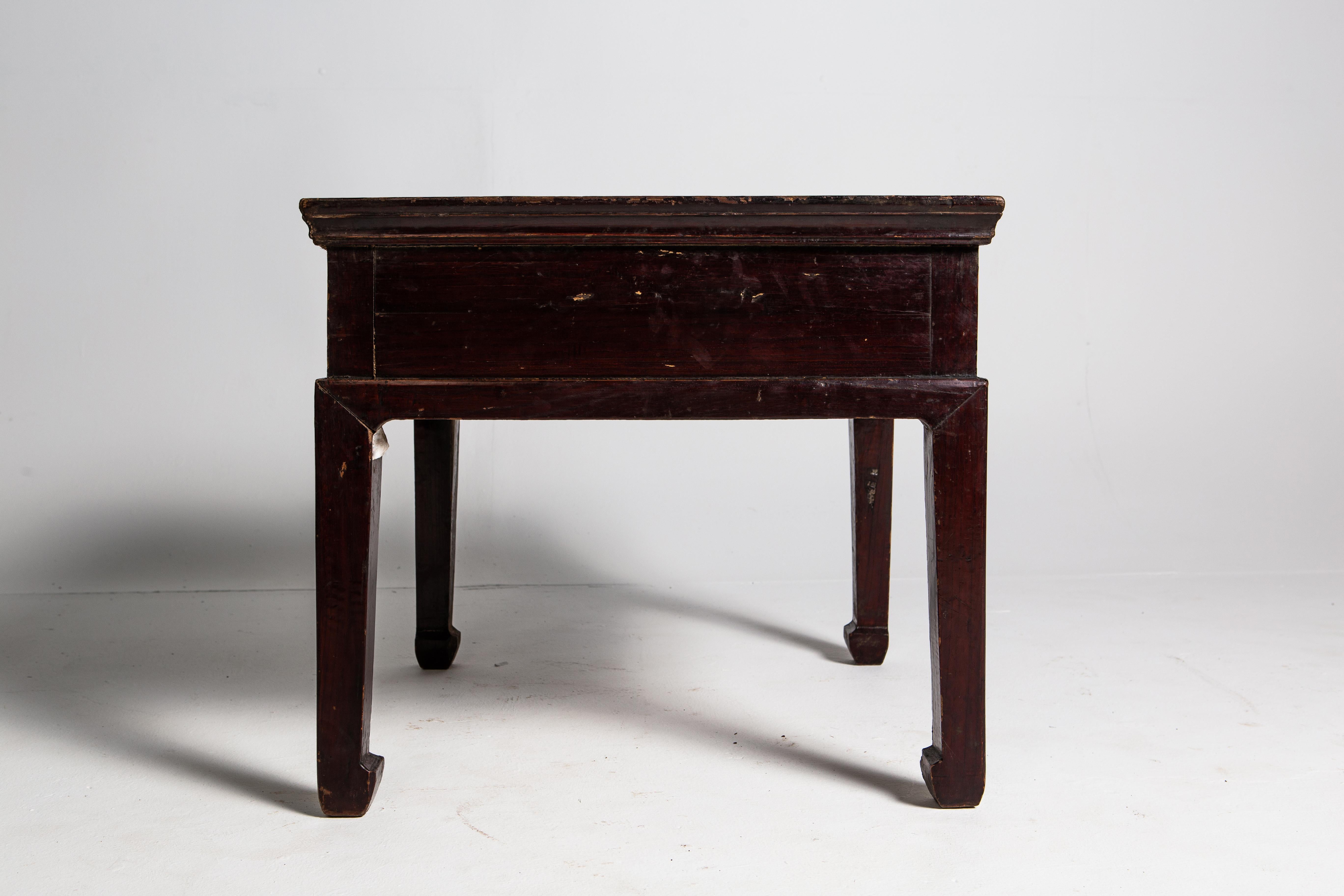 This table dates back to the late-Qing dynasty and is made of elm. The piece features a single drawer with ring-pull handle and rests on traditional hoof feet. Overall, the piece has a lovely patina, although there is wear consistent with its age