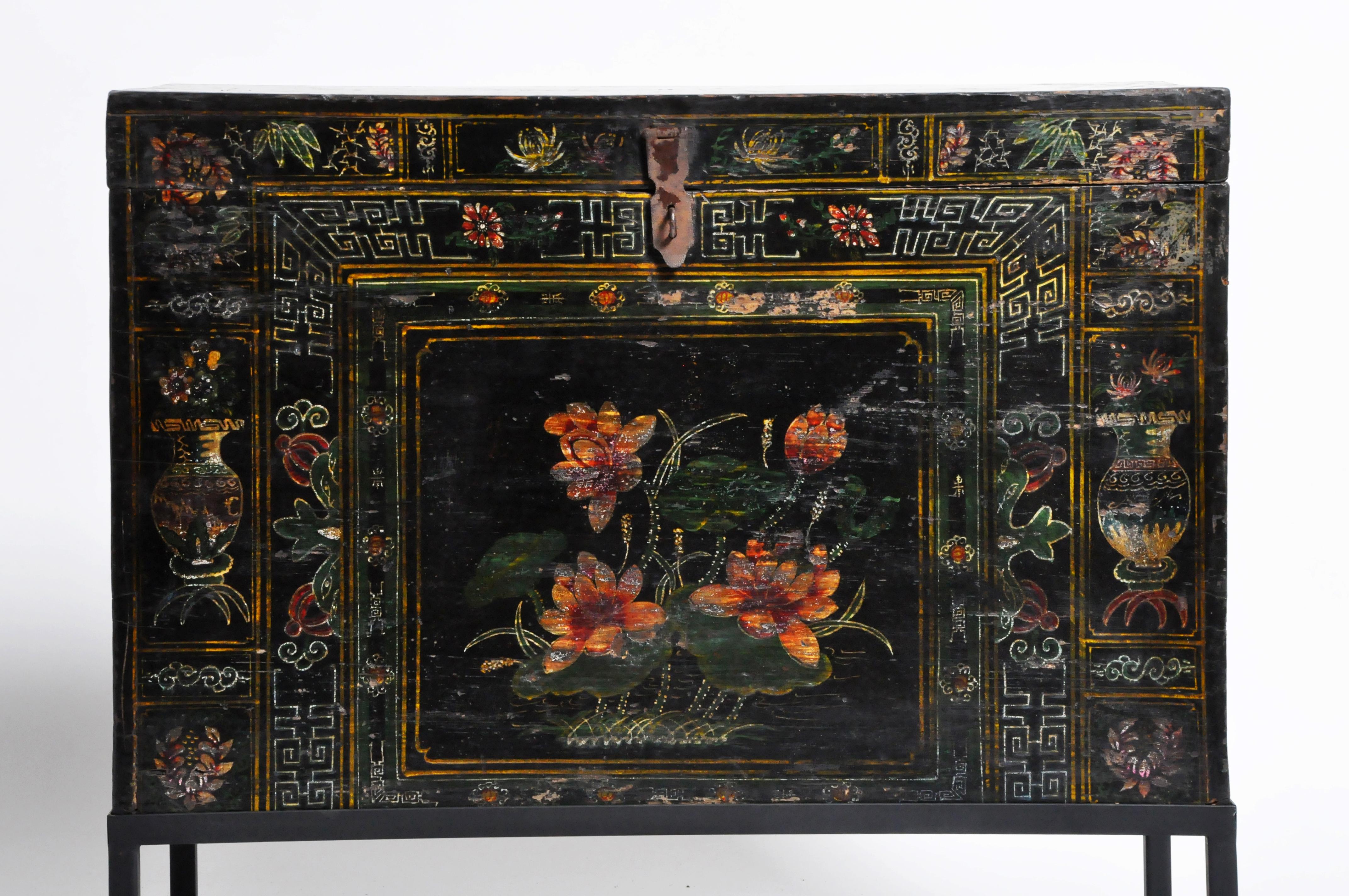 This gorgeous late Qing dynasty storage chest is from China and was made from elmwood and paint. The chest has been raised on a metal base and features beautifully painted artwork. Wear consistent with age and use. The base is newly made. 

The