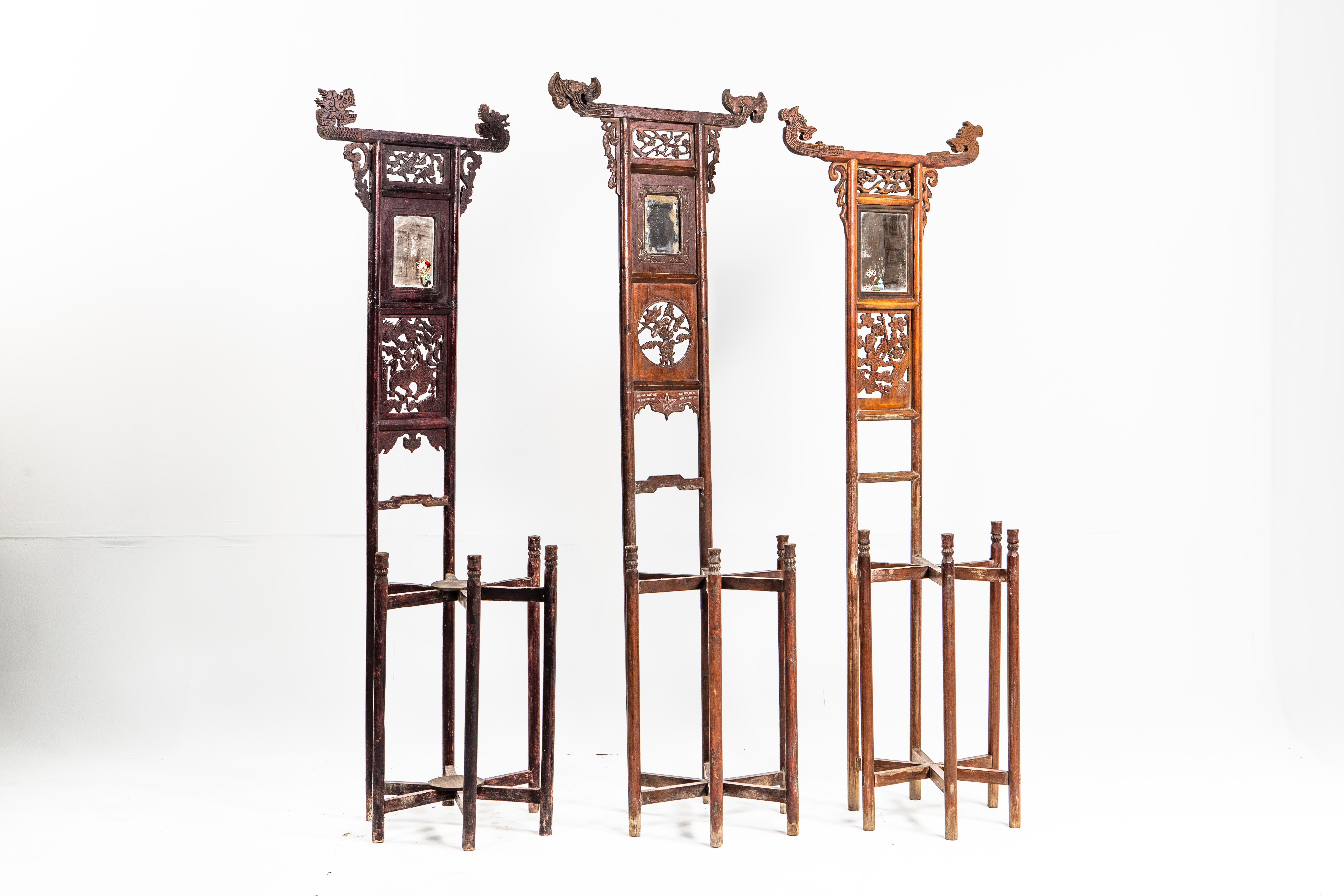 These washstands were designed to hold a brass bowl; the ends of their top rails upturned to keep towels in place. While many were plain, these pieces feature ornate carvings and paintings. These pieces date to the late-Qing Dynasty. Items are sold