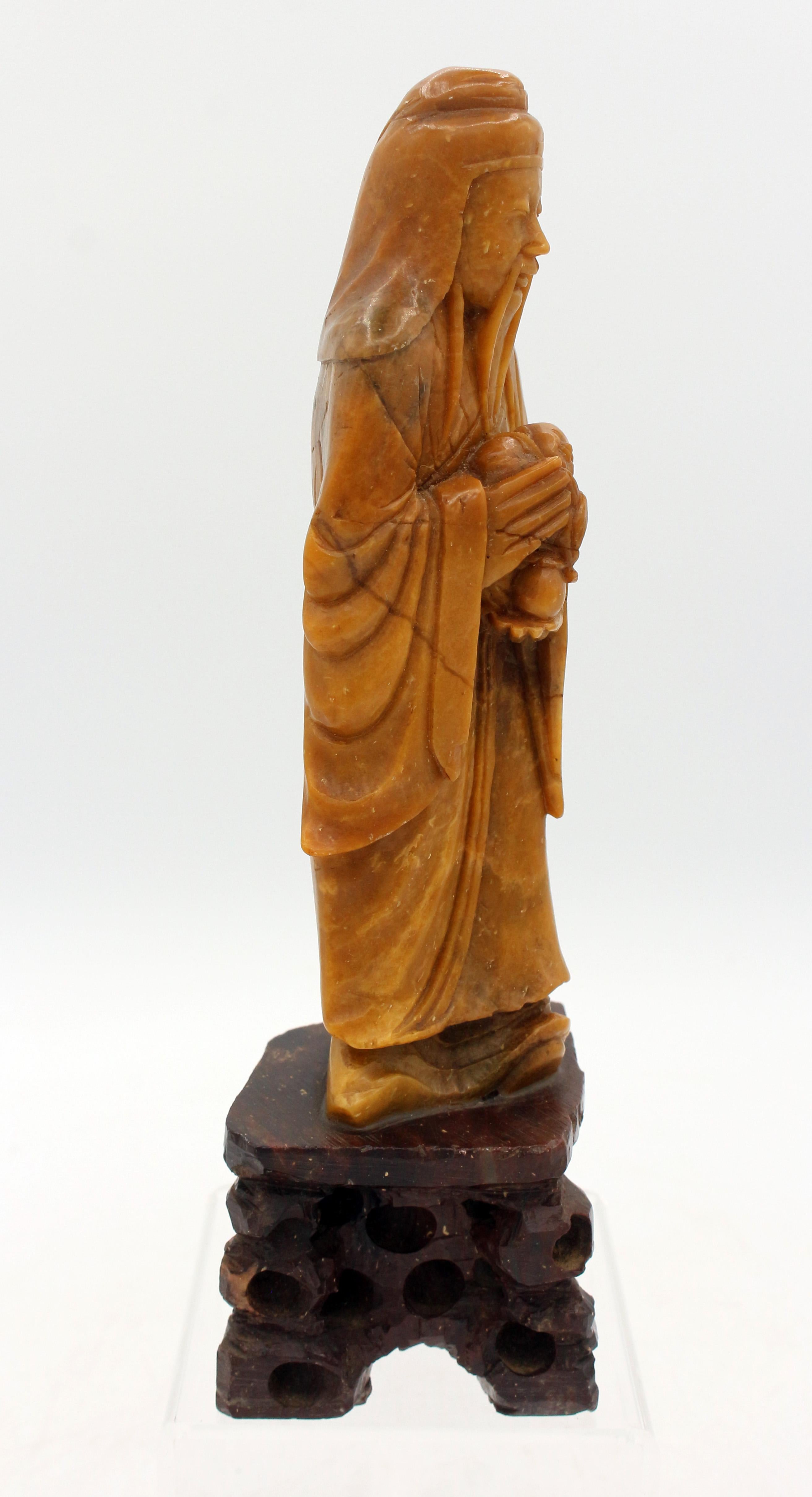 Late Qing, pre-1891 carved soapstone figure, Chinese. Elegantly carved of a wise man holding a baby & a peach on a carved rocky outcropping soapstone attached stand. Unmarked.
7 5/8