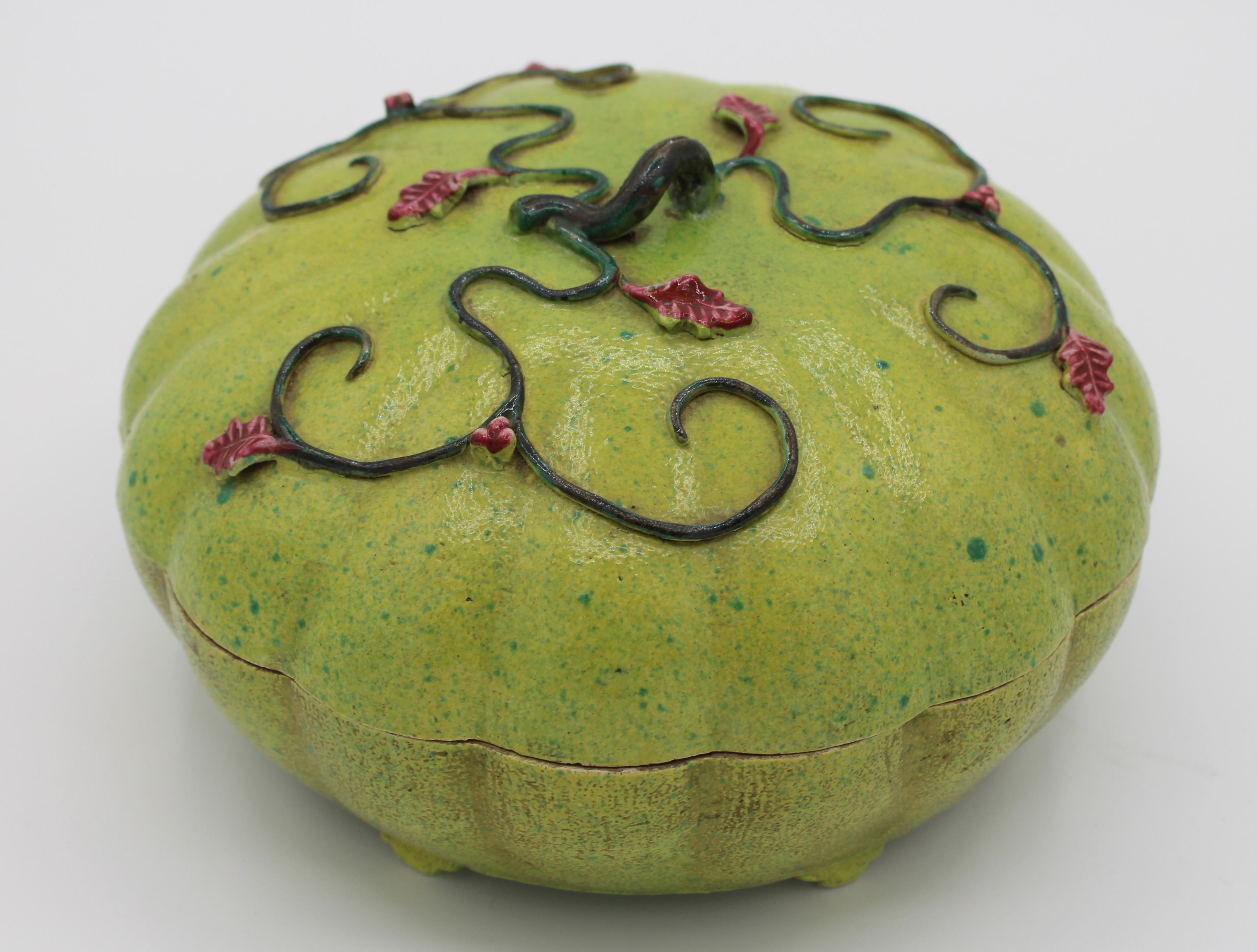 A delightful late Qing to early Republic period altar melon form covered bowl, divided for sweetmeats. Apple green glaze with famille rose leaves and berries. With 1981 Hong Kong case and receipt as over 100 years of age. One foot as it. 9 1/8