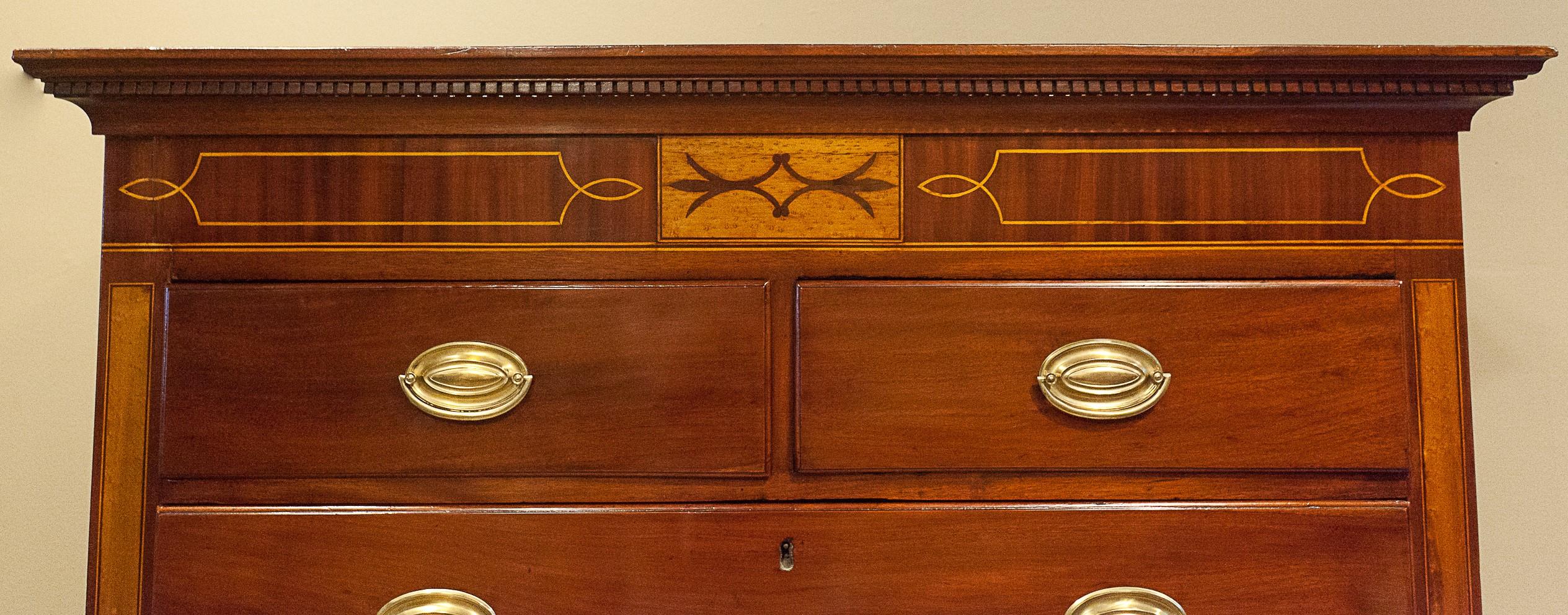 This Hepplewhite chest on chest is made of mahogany with bird's-eye maple, satinwood, and mahogany inlay, all French polished. The Hepplewhite solid brass pulls are replacements. The piece has two over six drawers for a total of eight drawers,